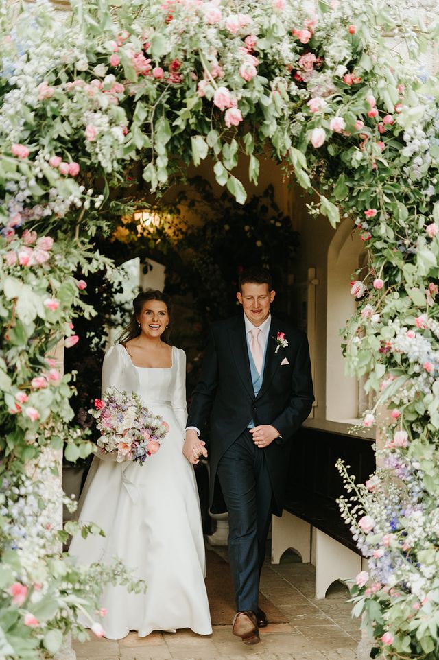 Bride and groom walking out of their wedding planned by luxury wedding planner