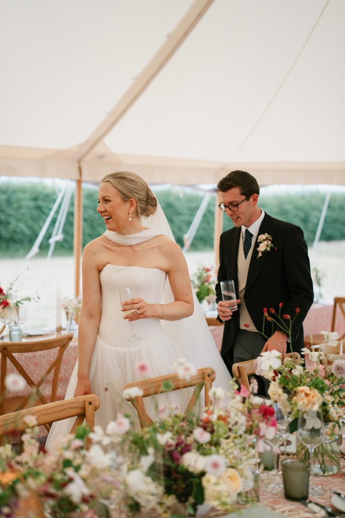 bride and groom looking at wedding design before guests take their seats for teh wedding breakfast - coordinated at Hardesty Event Design