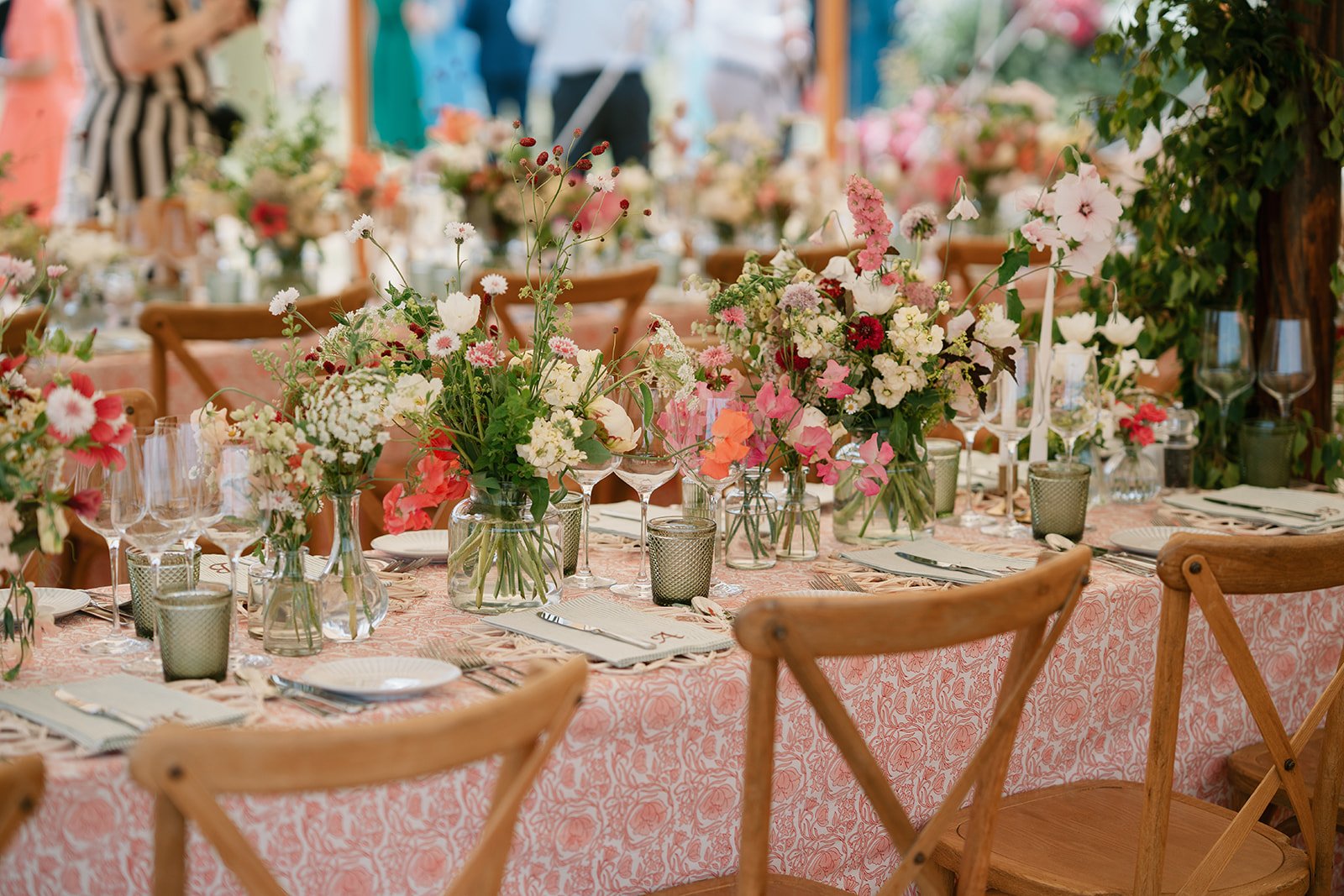 Glowing white marquee wedding reception filled with flowers set at a family residence in Lincolnshire