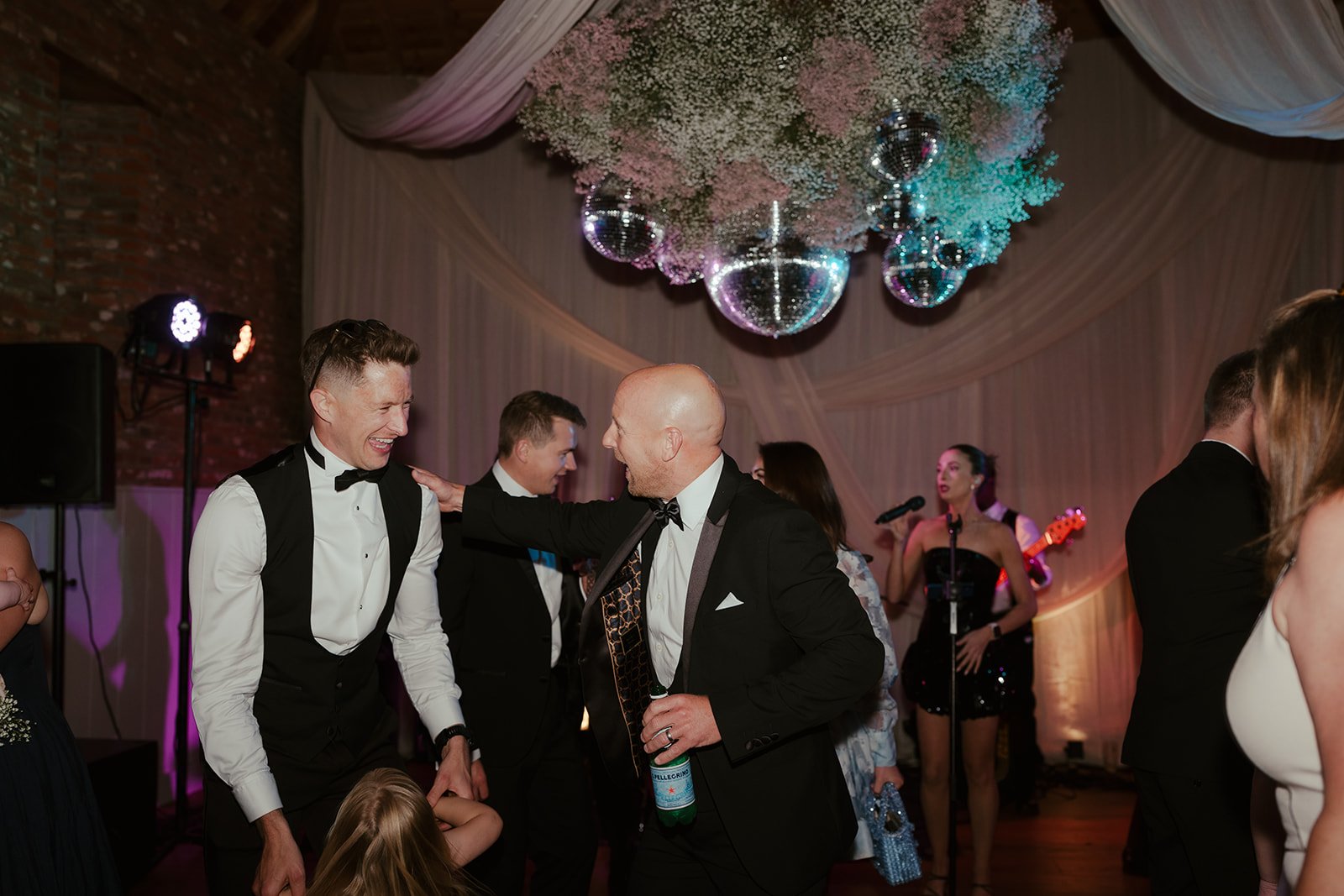 The groomsmen laughing at the evening wedding party, planned by Hardesty Event Design