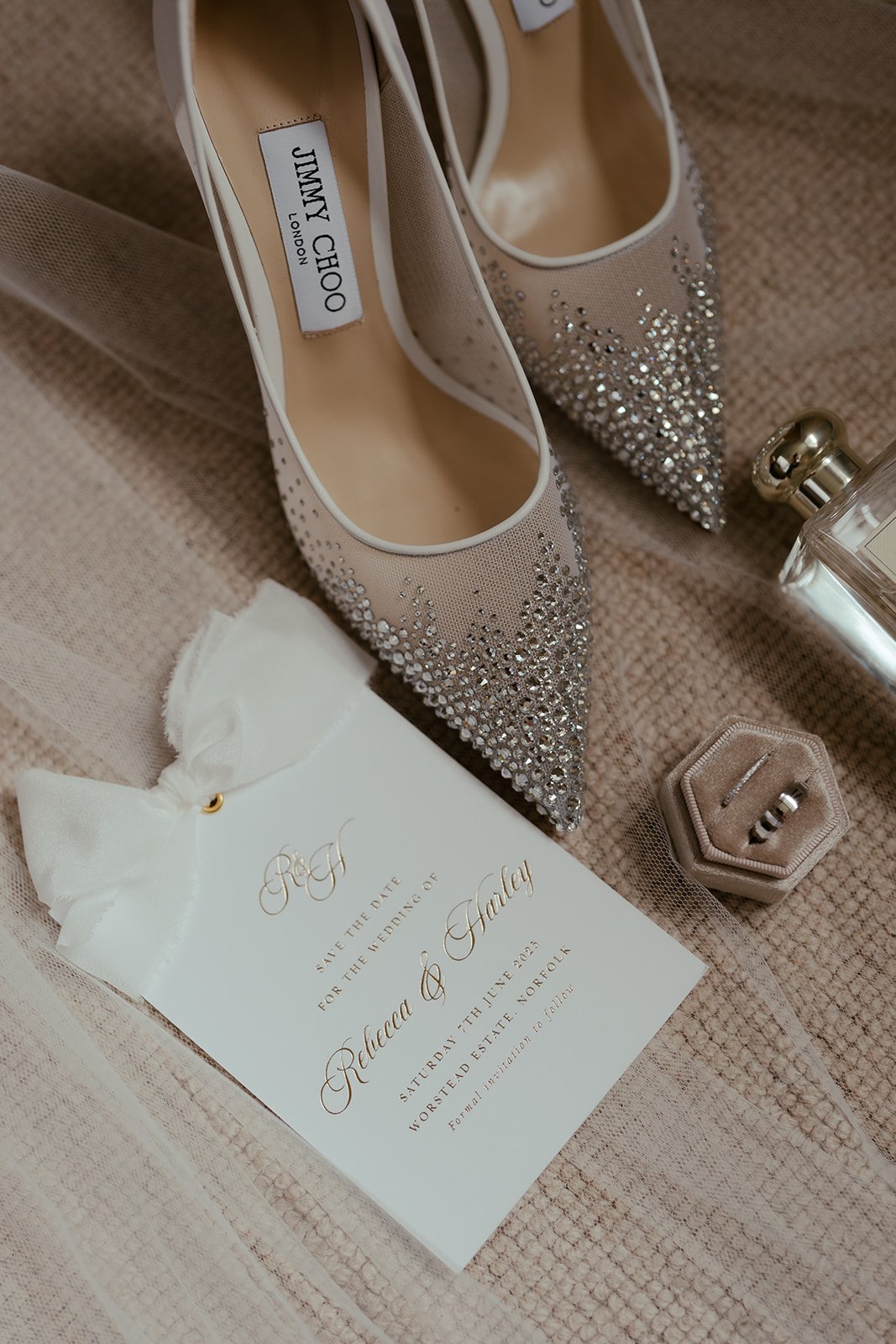 Wedding bridal prep with the invite, wedding bands, perfume and Jimmy Choo shoes