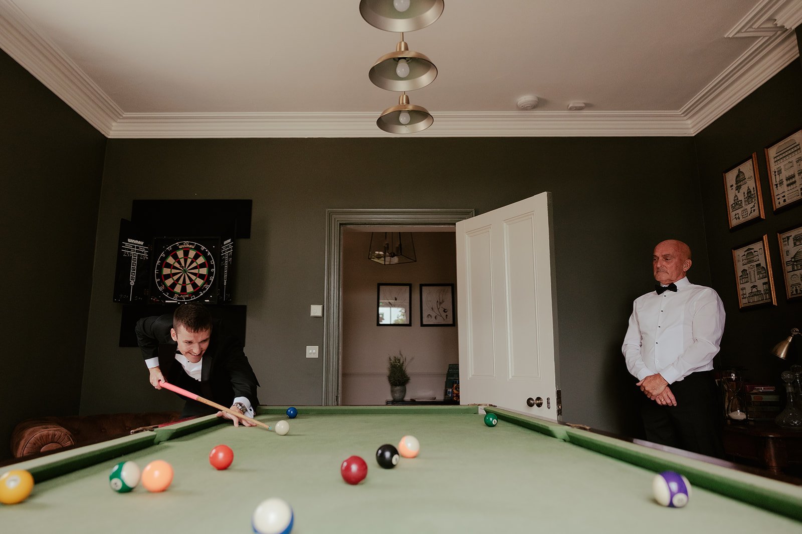 Groom and groomsmen playing pool pre-wedding
