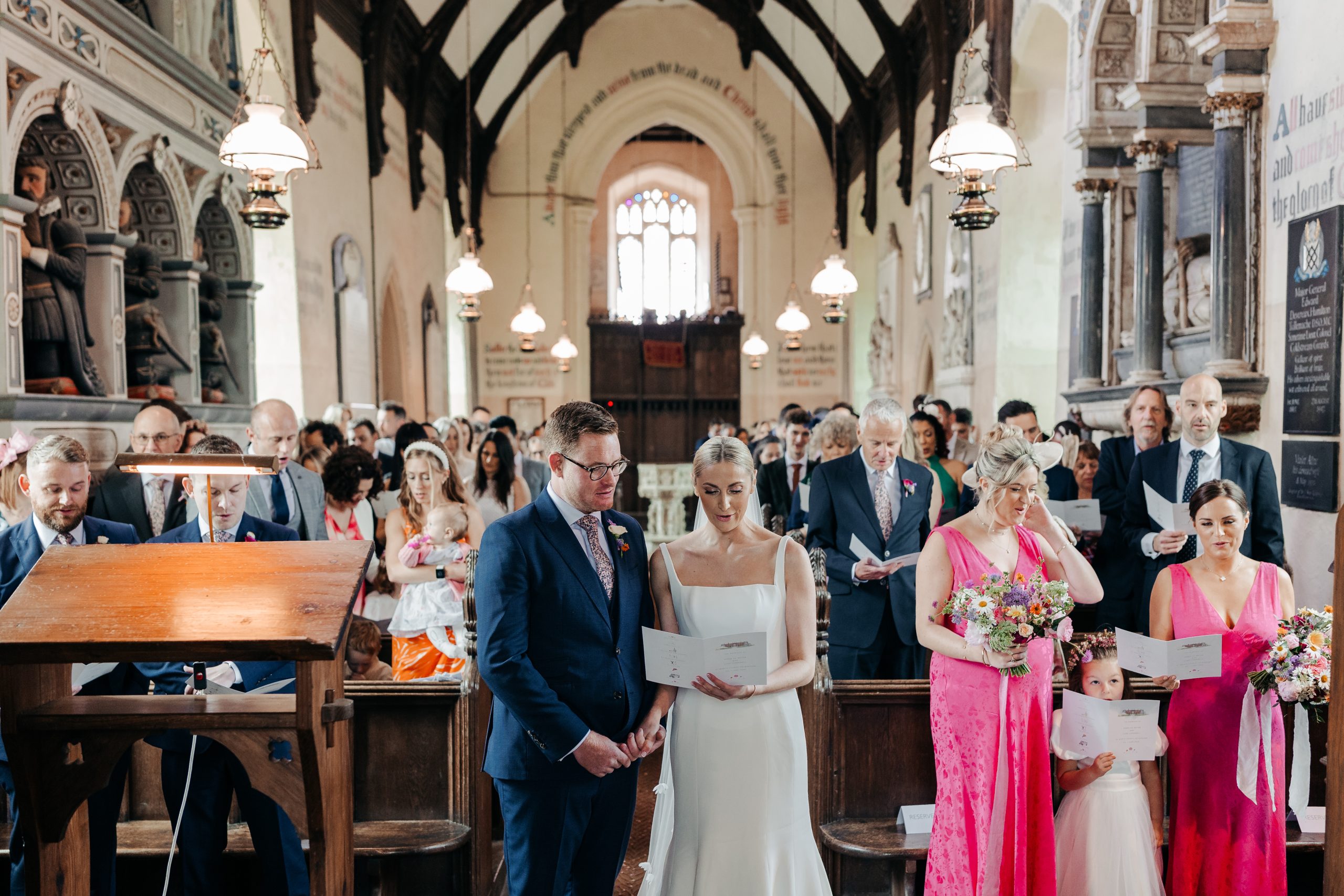 Bride and groom stood at the front of the aisle during their church service coordinated by UK wedding planners, Hardesty Event Design
