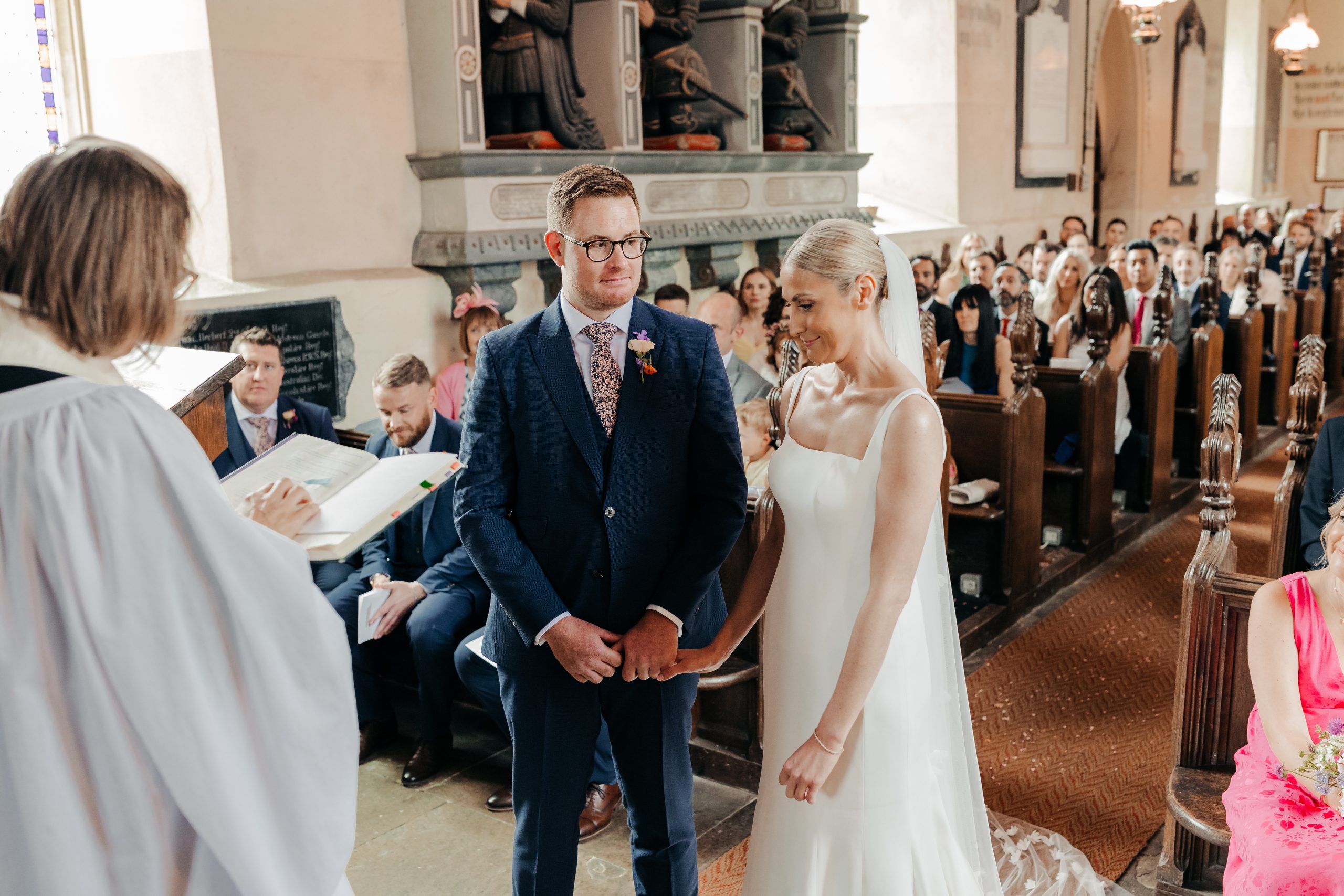 Bride and groom stood at the front of the aisle on their wedding day during the church service, coordinated by Hardesty Event Design
