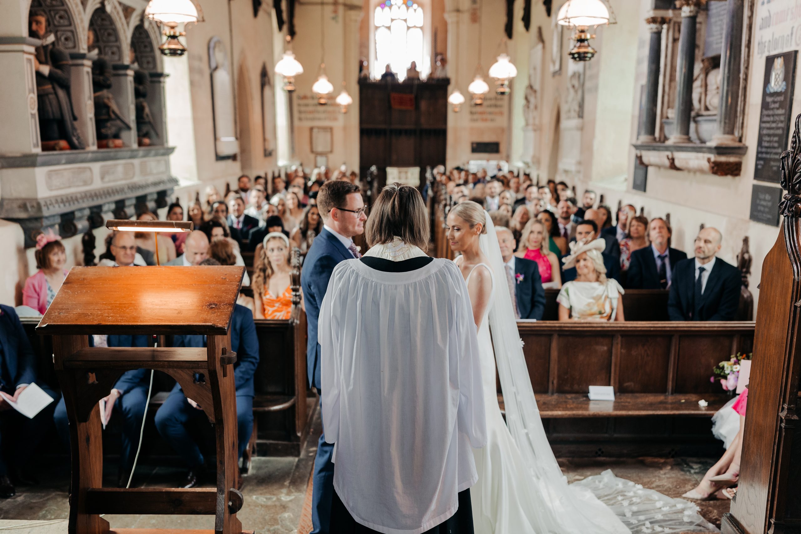 Bride and groom exchanging vows at a high-end country house wedding in Norfolk planned by a luxury UK wedding planner