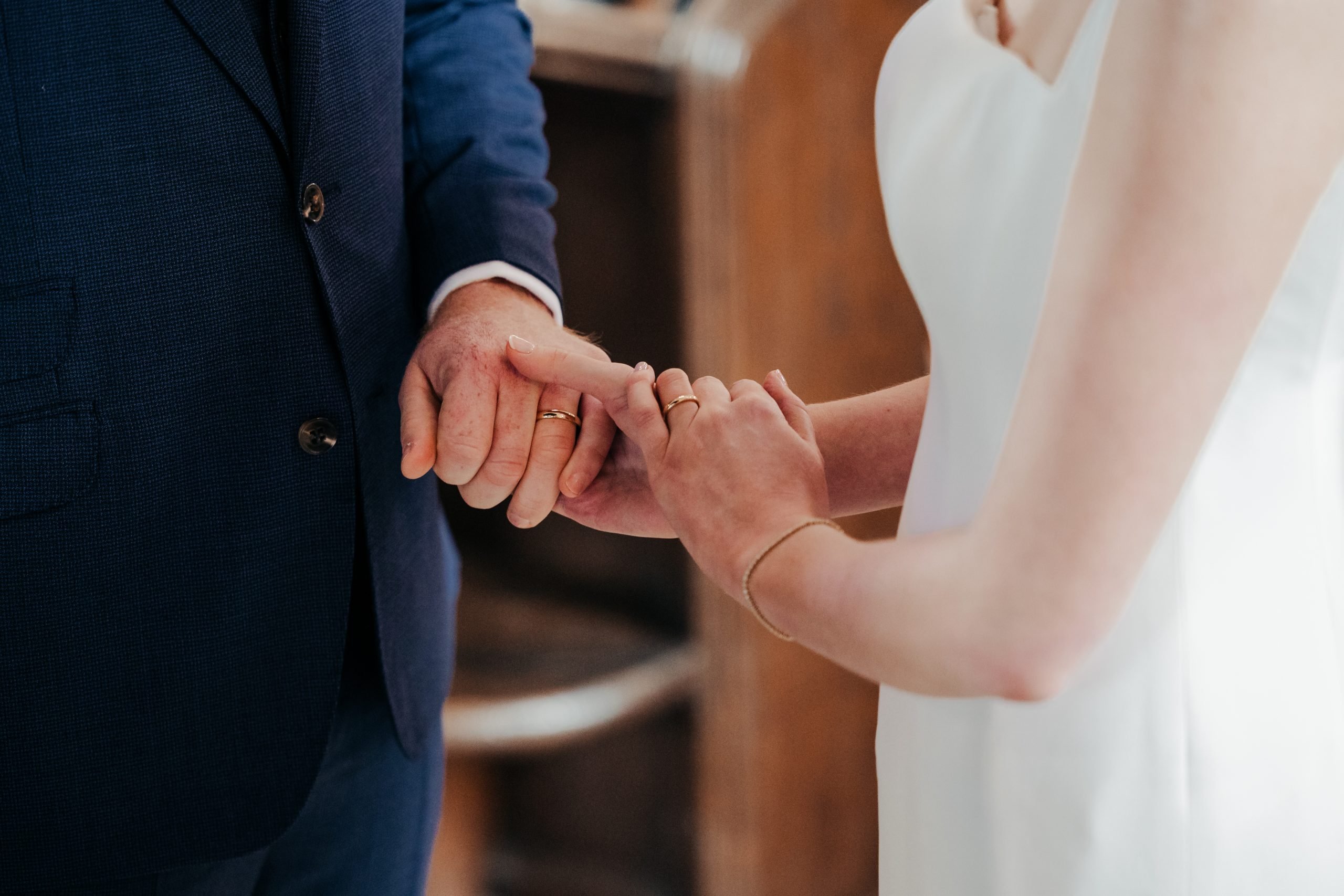 Bride and groom exchanging rings at a high-end country house wedding in Norfolk planned by a luxury UK wedding planner