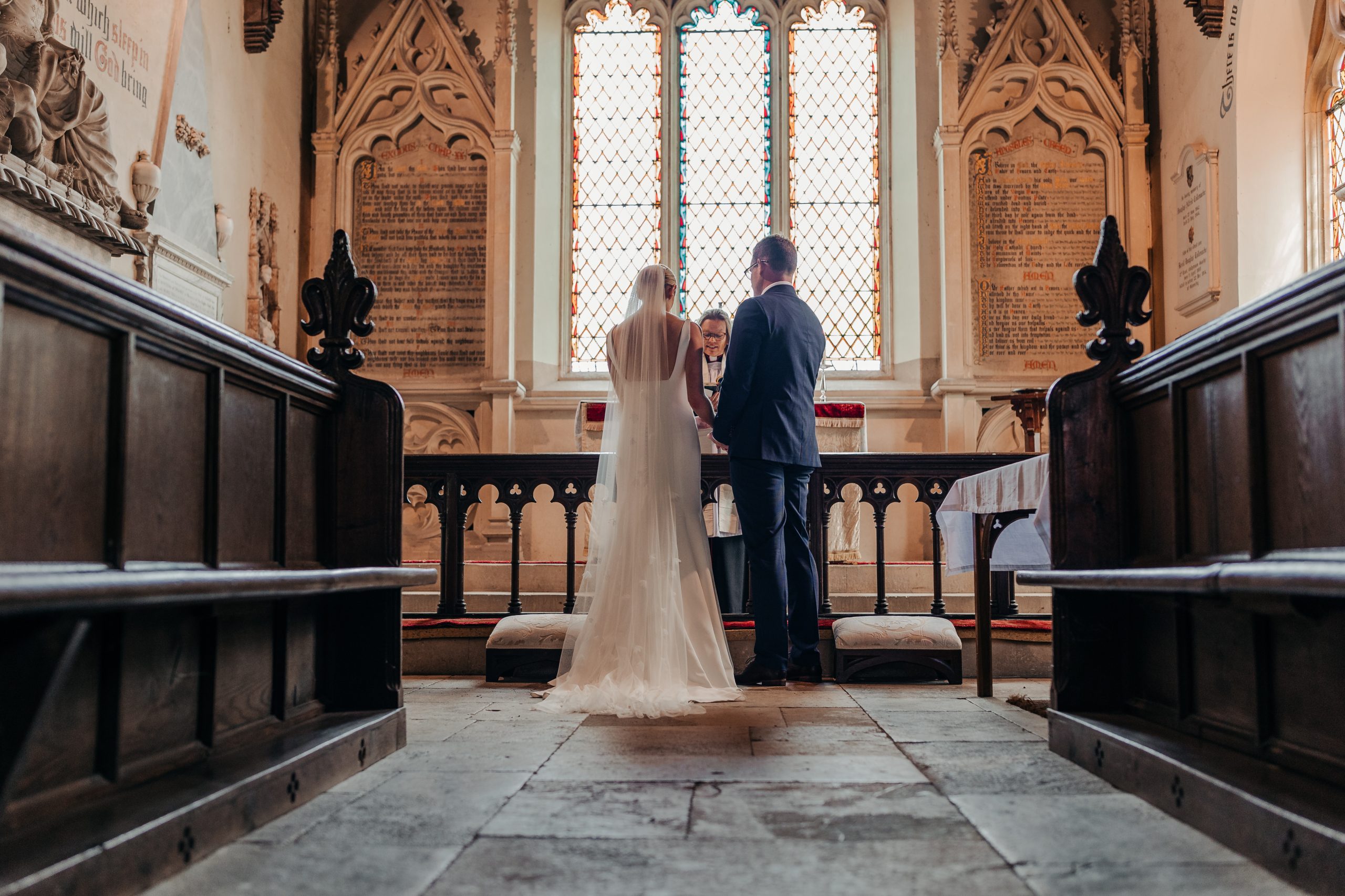 Bride and groom exchanging vows at a high-end country house wedding in Norfolk planned by a luxury UK wedding planner