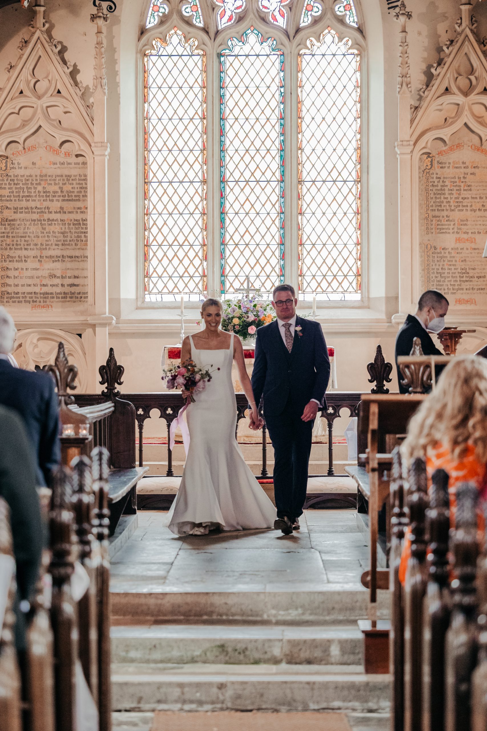 Bride and groom newly married following the exchange of rings and vows at a country house wedding in Norfolk, captured at a luxury wedding weekend event