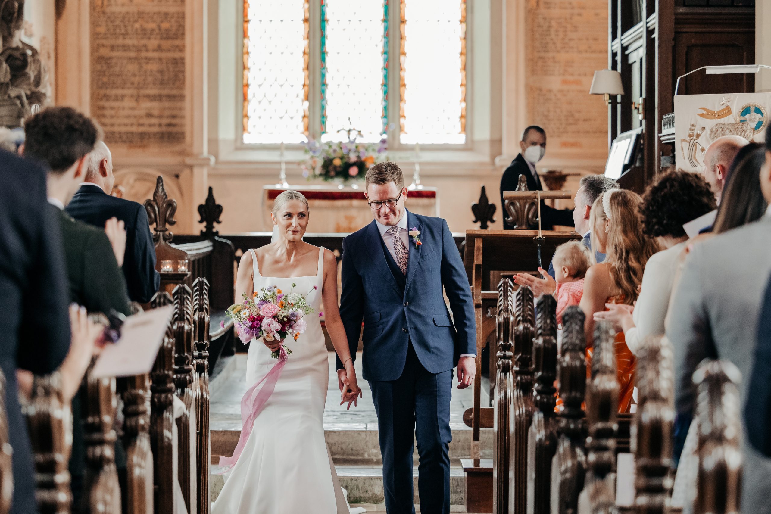 Bride and groom newly married following the exchange of rings and vows at a country house wedding in Norfolk, captured at a luxury wedding weekend event