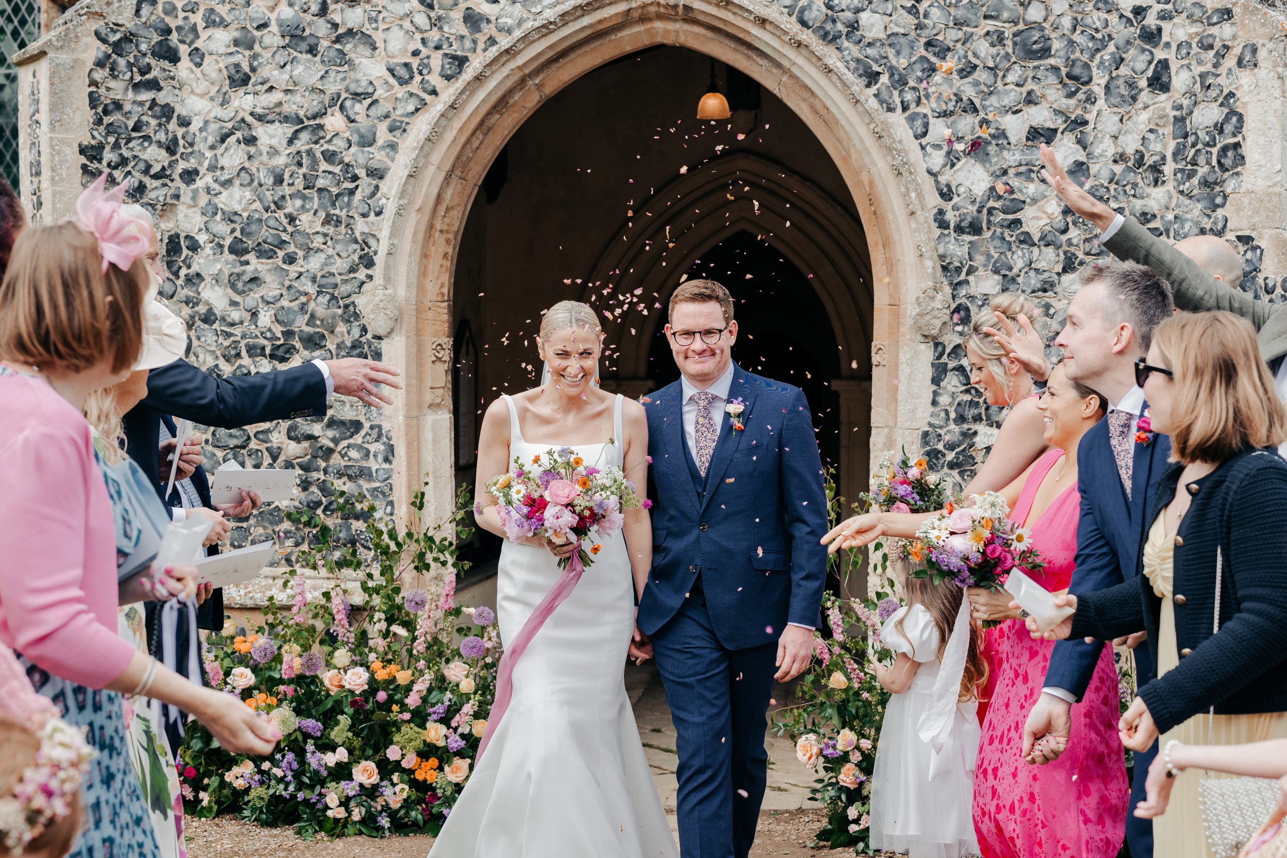 Emma & Luke sharing a moment outside their church, styled by a high-end UK wedding planner