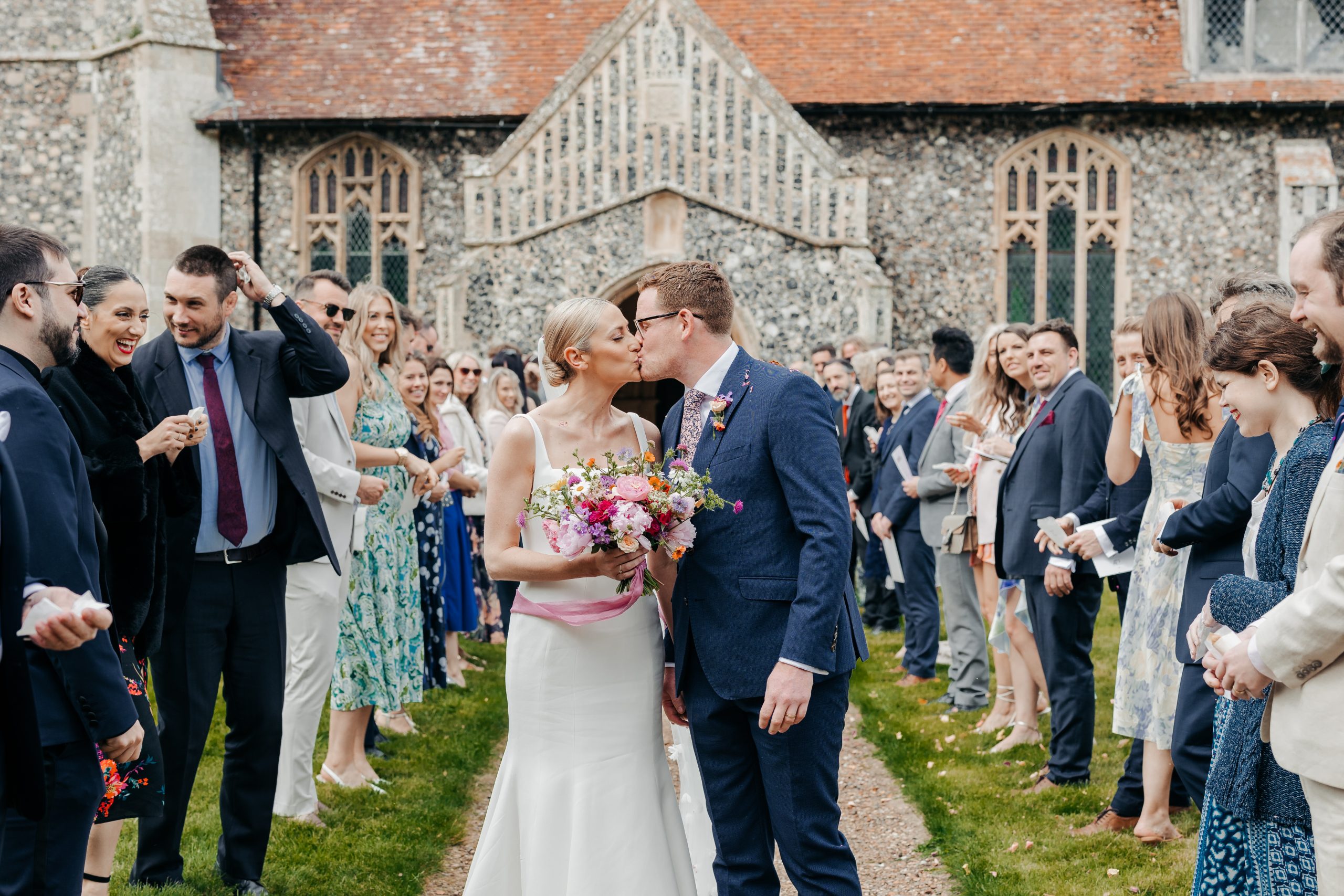 bride and groom exchanging a kiss outside the church on their wedding day, coordinated by Hardesty Event Design