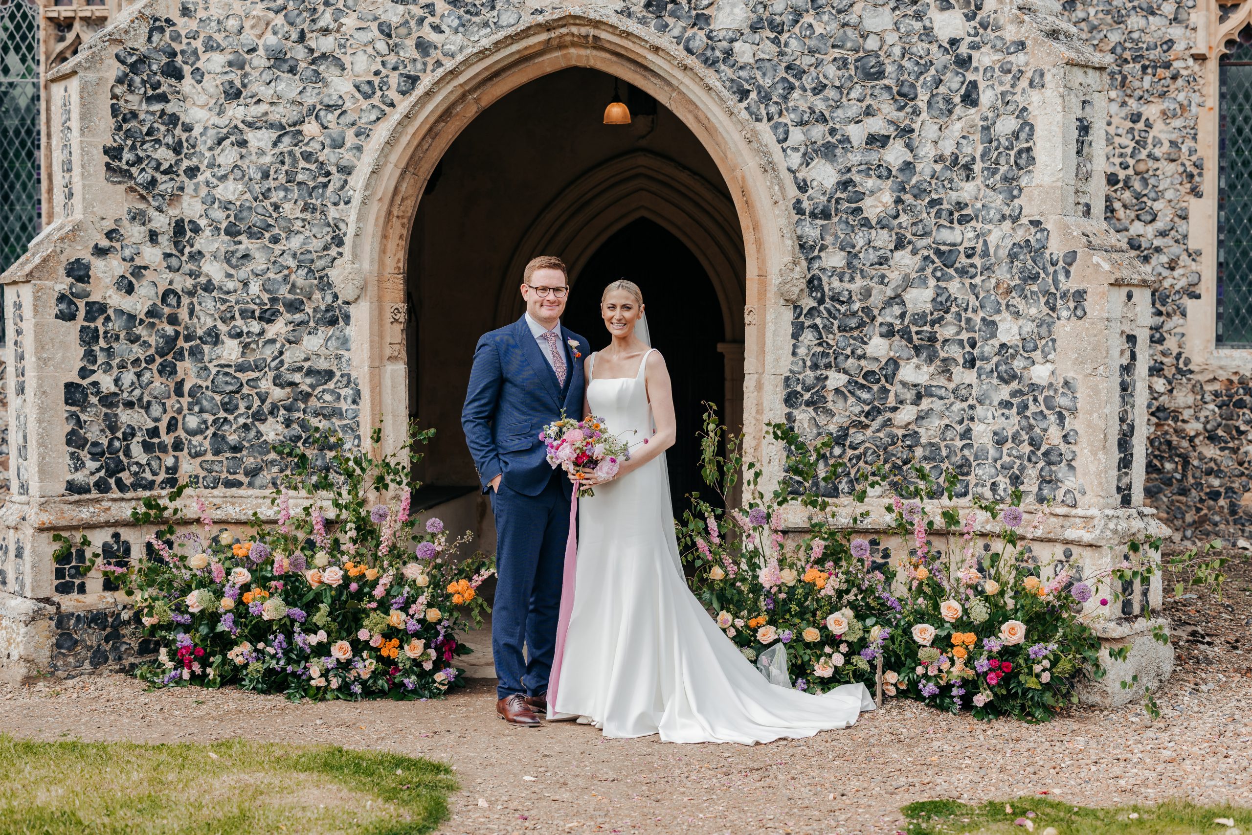 bride and groom outside their church on their luxury wedding day in Suffolk, coordinated by Hardesty Event Design
