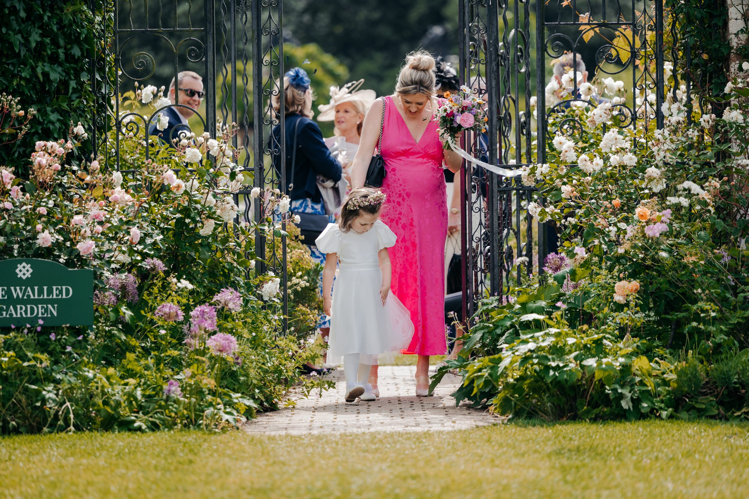wedding guests enjoying the grounds at Helmingham Hall, Suffolk, at a marquee wedding, expertly planned by Hardesty Event Design