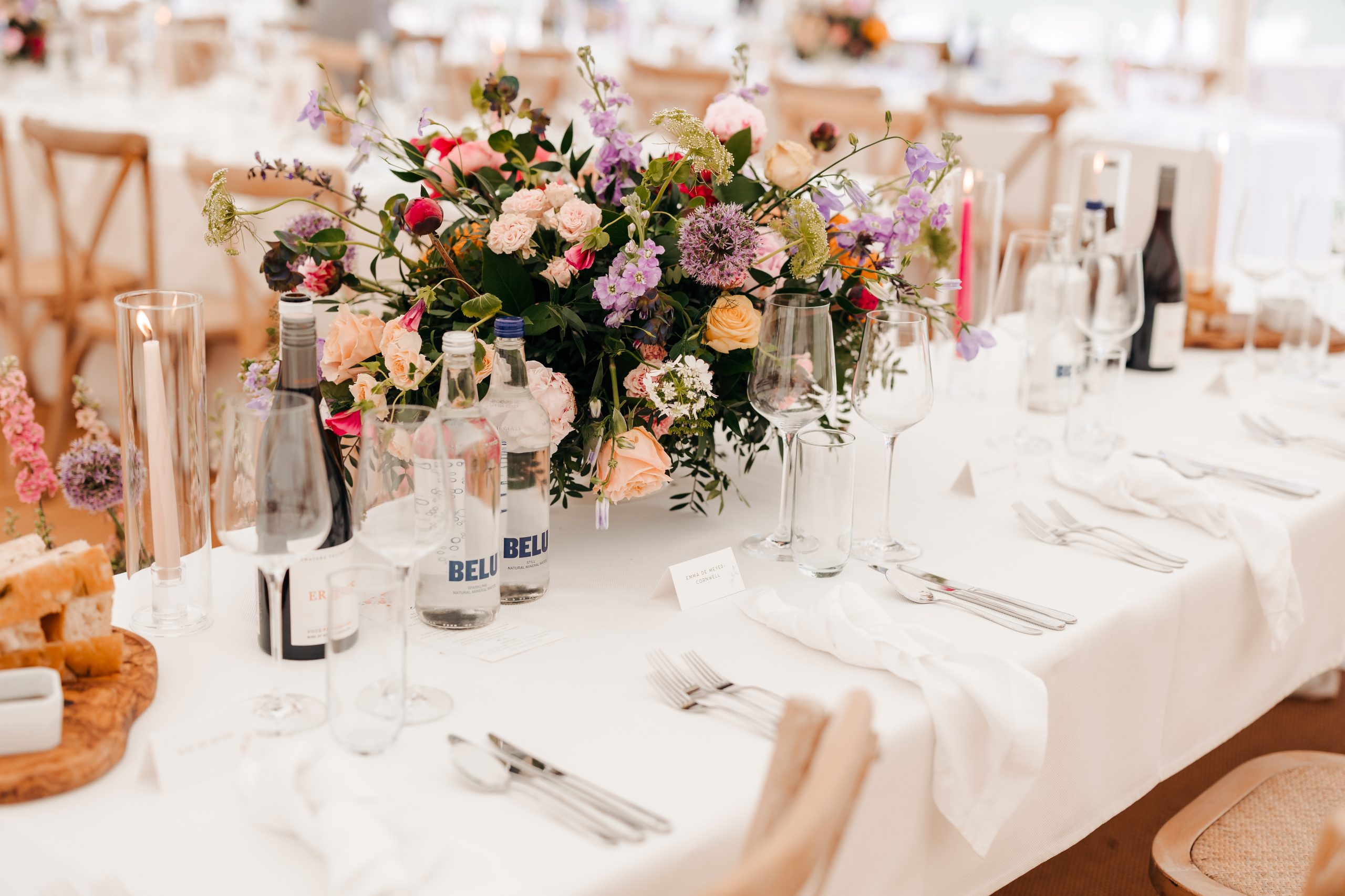 Close-up of elegant stationery and floral décor from a marquee wedding at Helmingham Hall, planned by UK wedding planners Hardesty Event Design