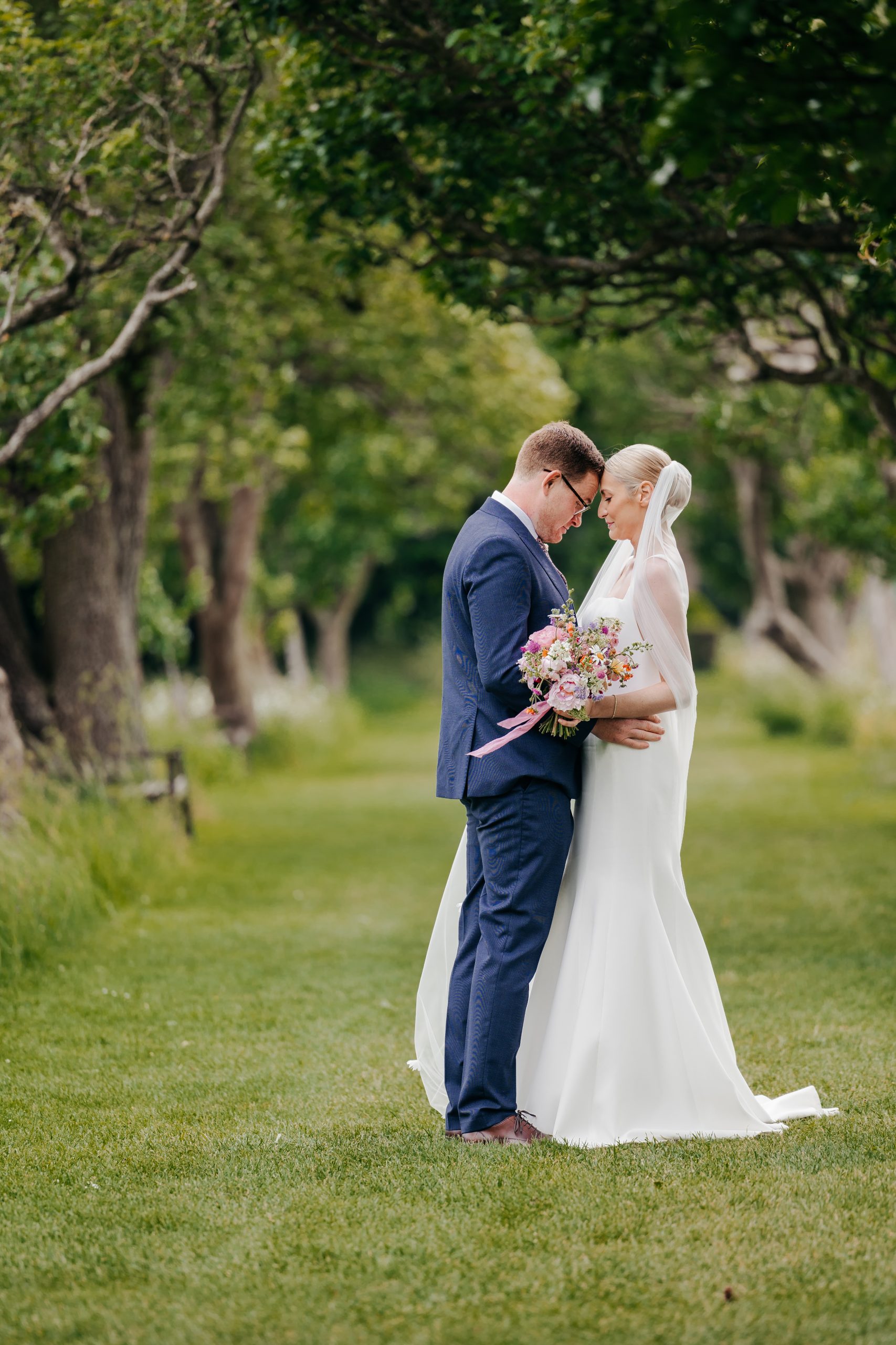 Emma & Luke sharing a moment outside their marquee, styled by a high-end UK wedding planner