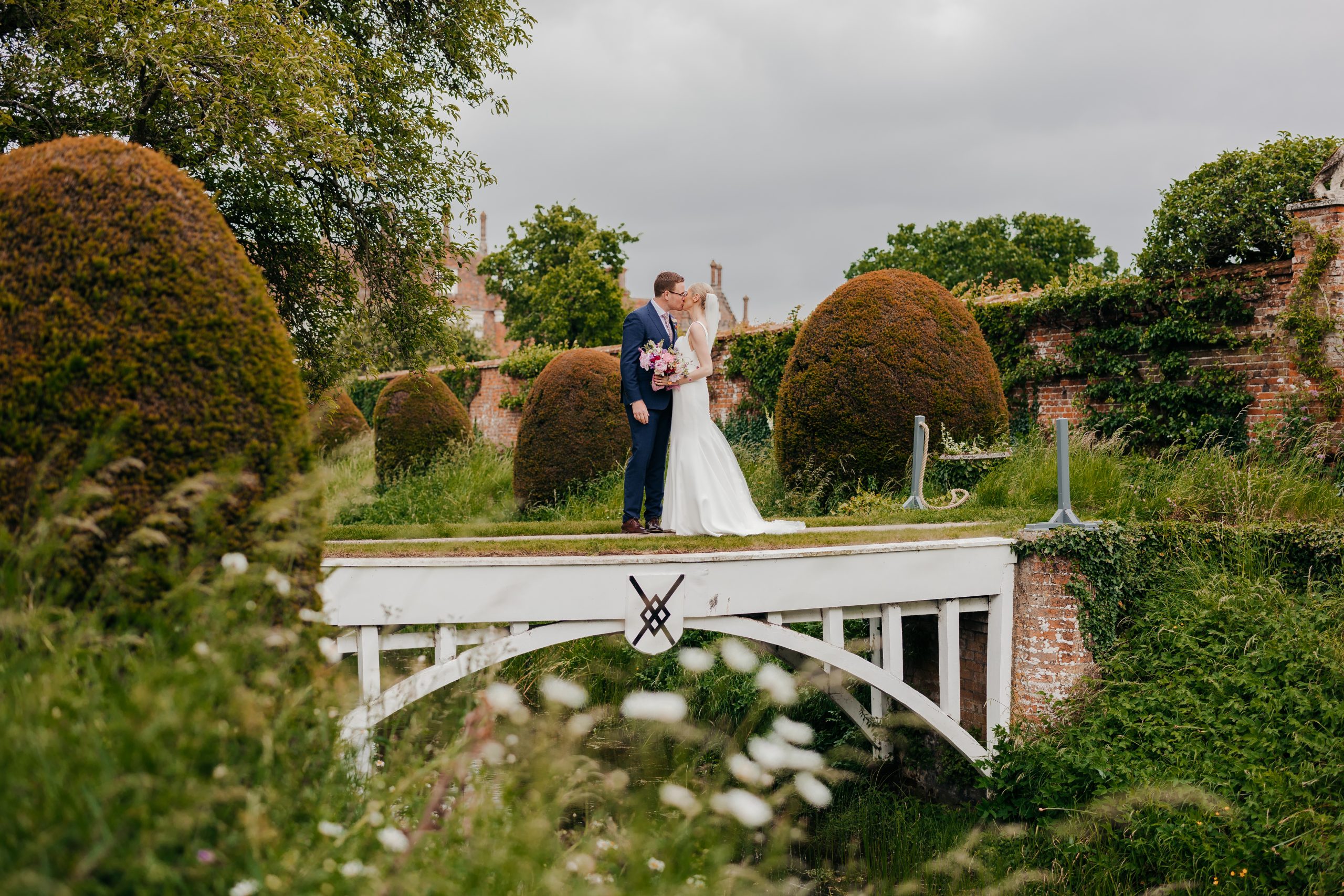 Emma & Luke sharing a moment in the grounds of country house wedding venue, styled by a high-end UK wedding planner