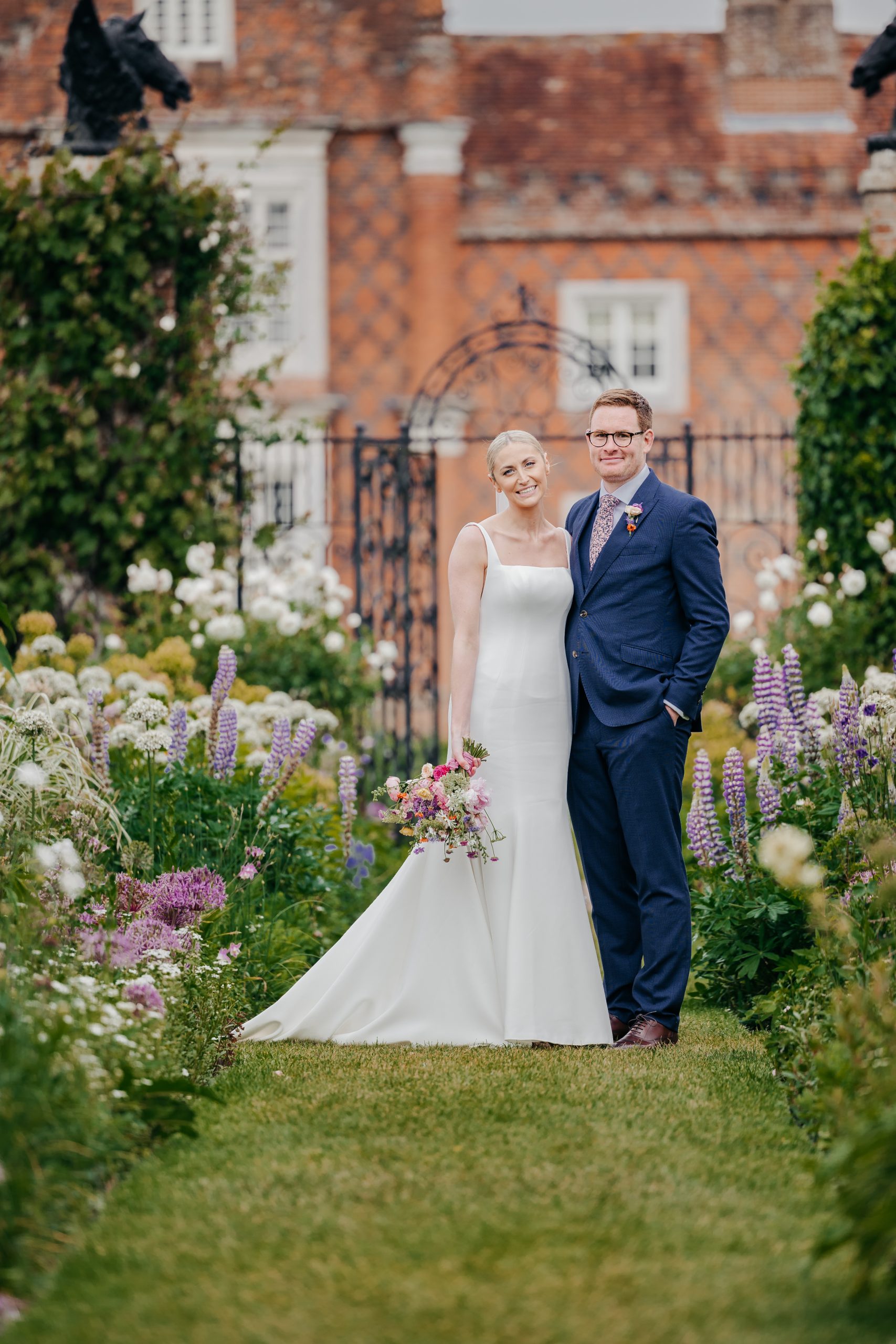 Emma & Luke sharing a moment in the grounds of country house wedding venue, styled by a high-end UK wedding planner