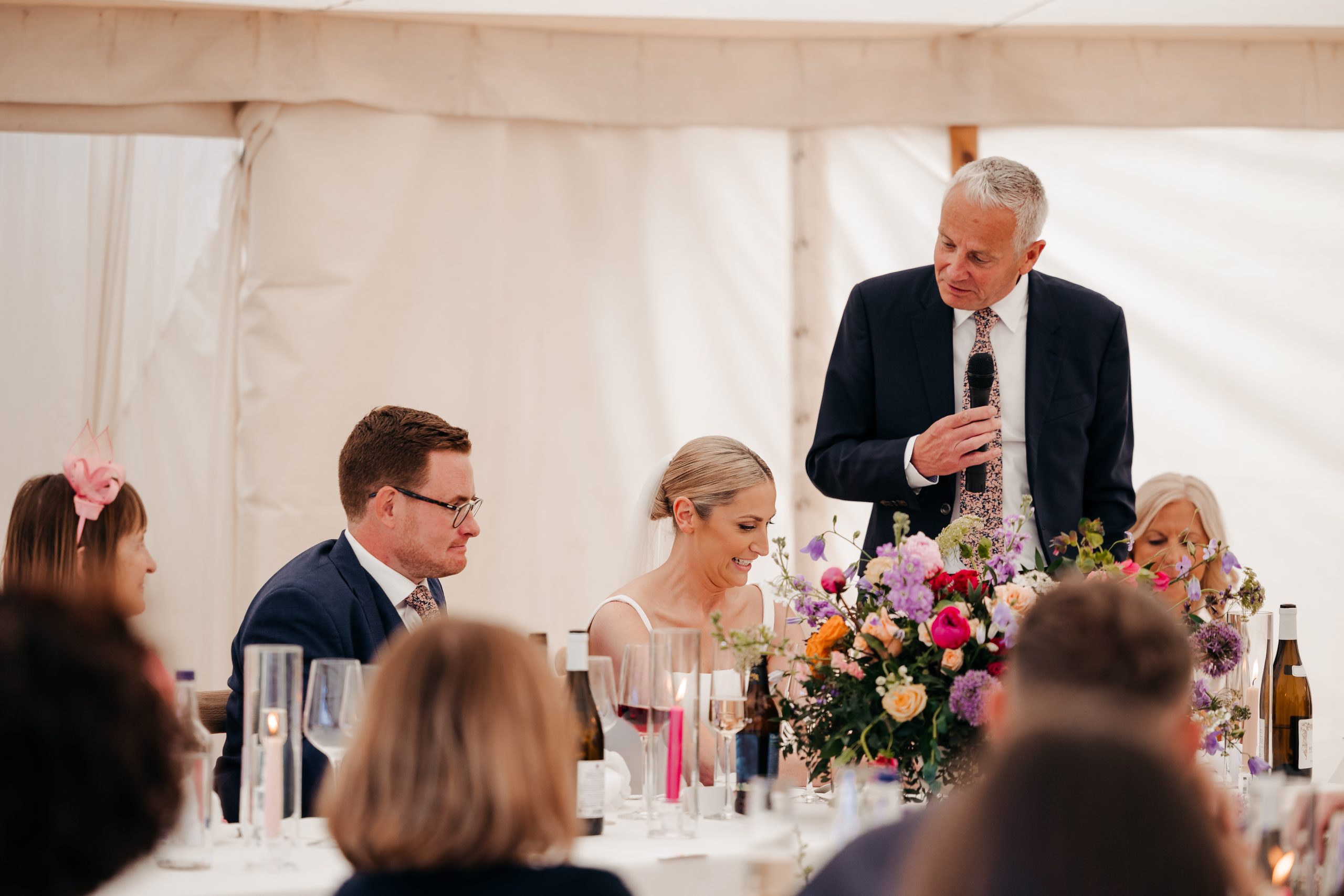 bride and groom on their wedding day listening to the father of the bride's speech, coordinated by Hardesty Event Design