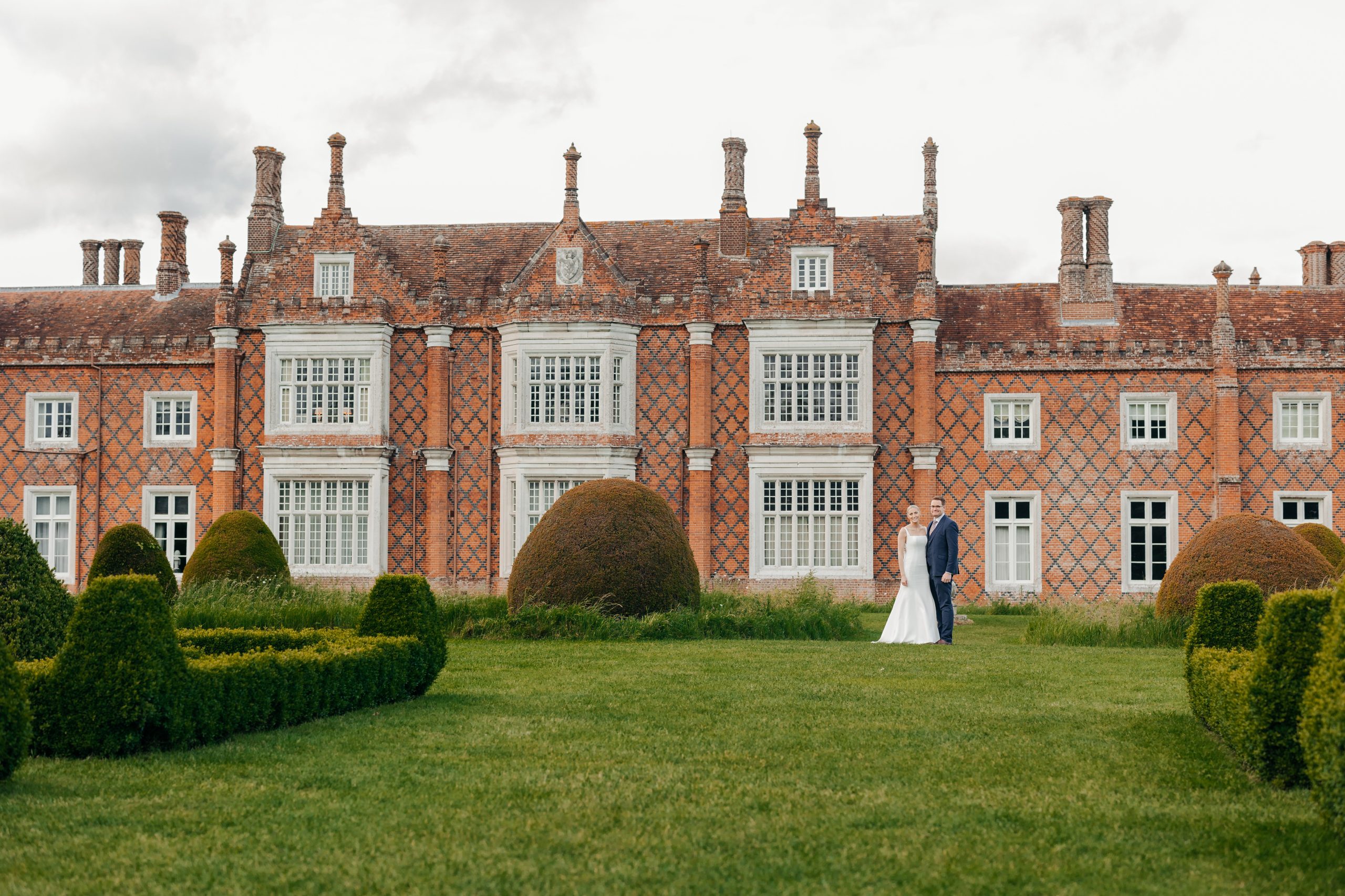 Bride and groom portrait in the grounds of Helmingham Hall during their marquee wedding