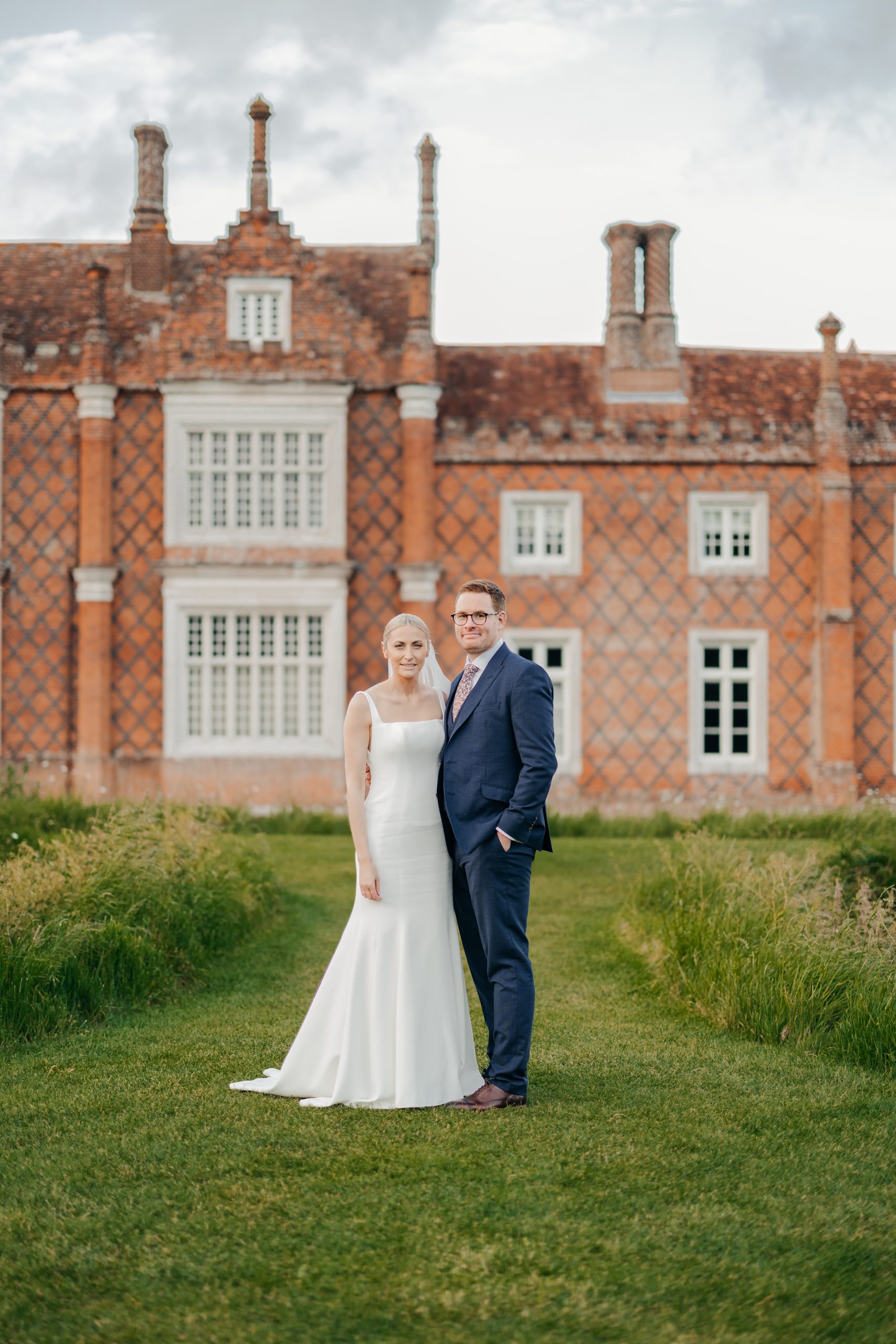 Bride and groom portrait in the grounds of Helmingham Hall during their marquee wedding in Suffolk