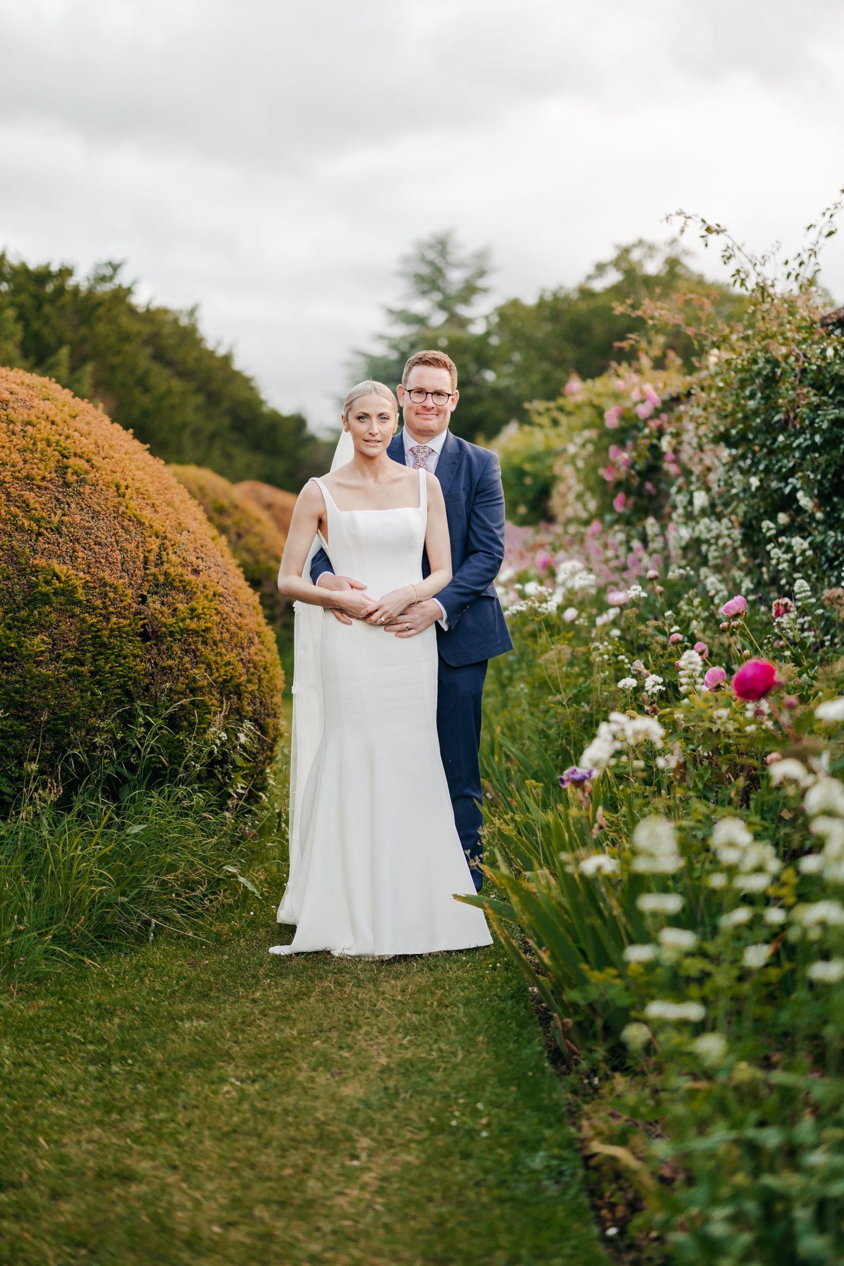 Bride and groom portrait in the grounds of Helmingham Hall during their marquee wedding reception in Suffolk