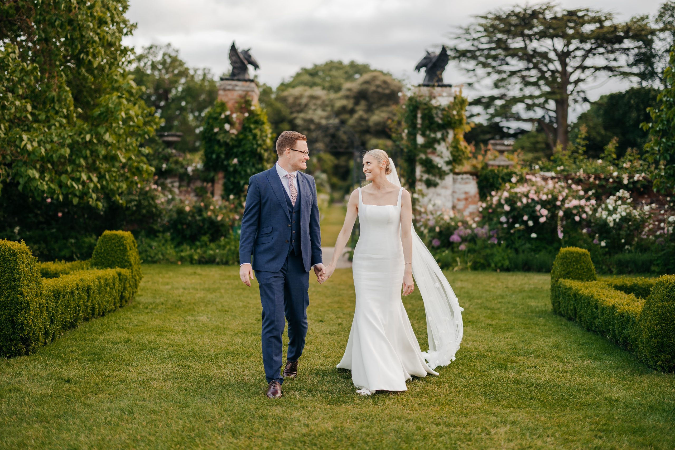 Emma & Luke sharing a glance outside their marquee, styled by a high-end UK wedding planner