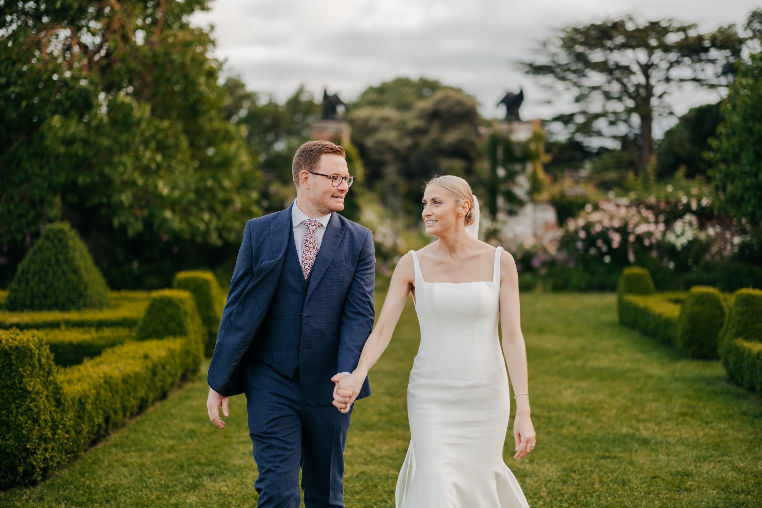 Emma & Luke sharing a moment and enjoying the grounds outside their marquee, styled by a high-end UK wedding planner