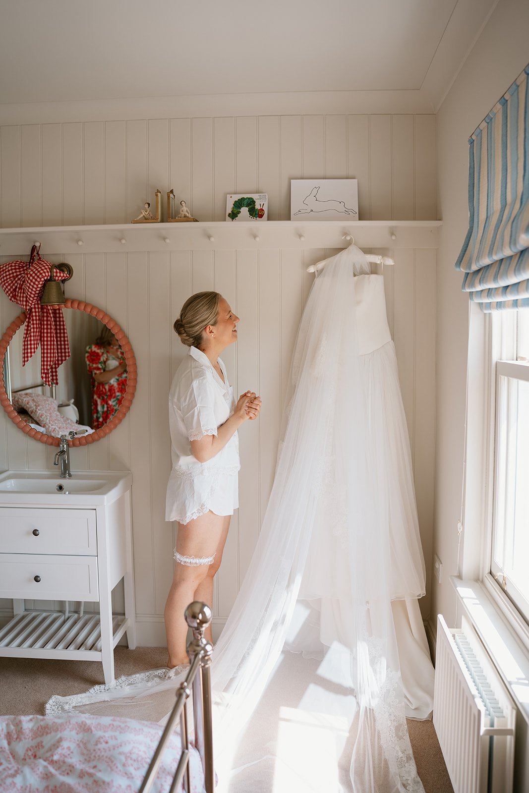 a gorgeous bride on the morning of her luxury wedding ready to put on her bespoke made Emma Beaumont bridal gown
