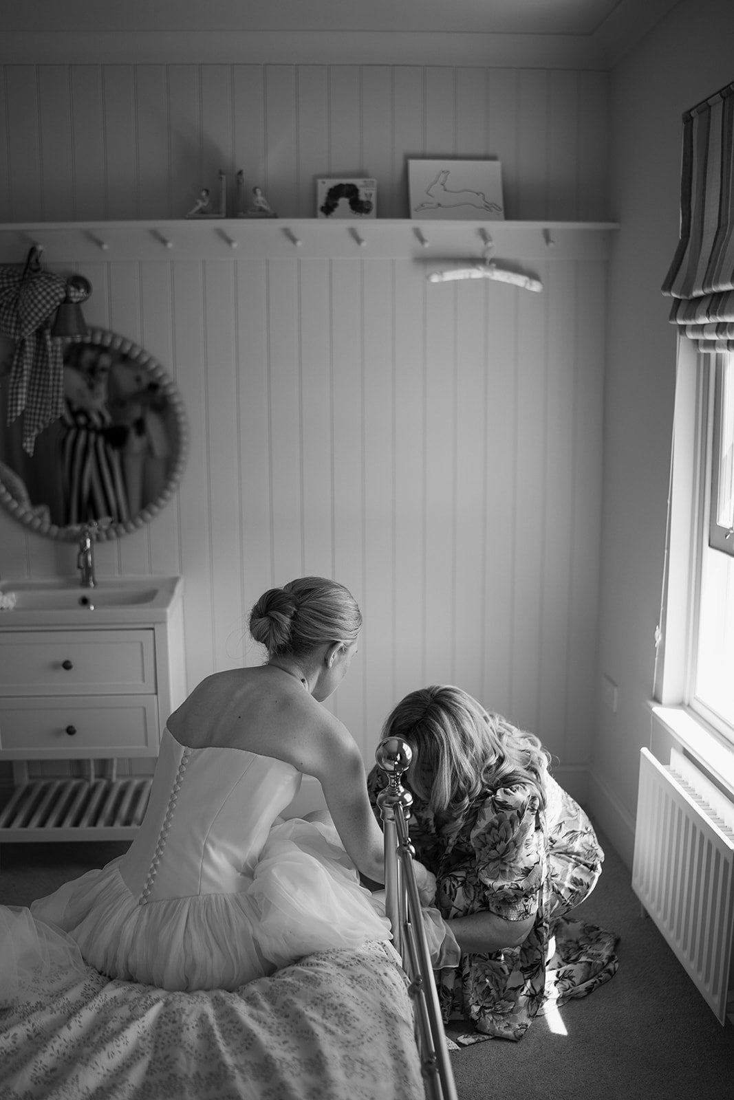 a gorgeous bride on the morning of her luxury wedding dressed in her bespoke made Emma Beaumont bridal gown with the help from Mother of the Bride
