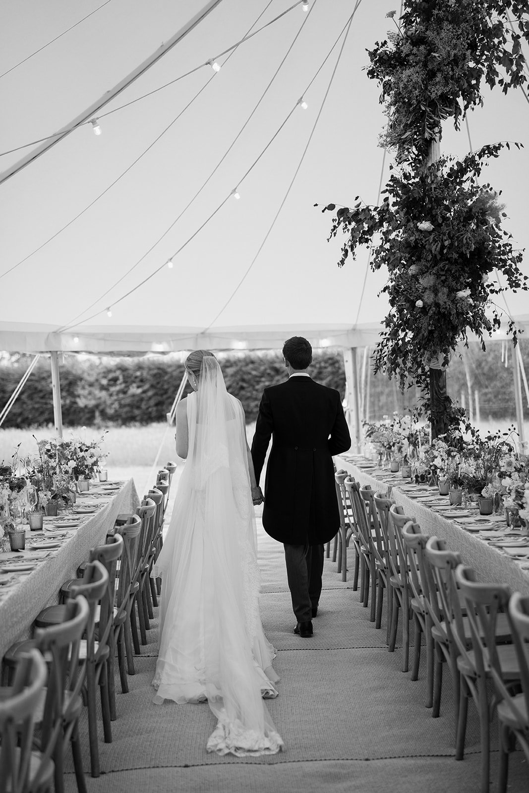 Bride and groom standing together in their garden marquee wedding, coordinated by Hardesty Event Design