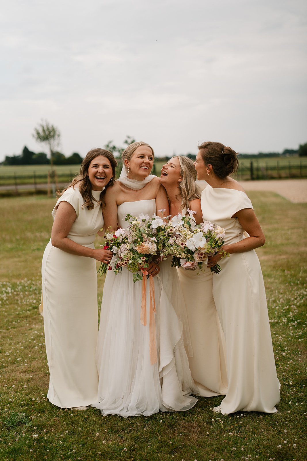 Charlotte with her bridesmaids during the drinks reception of her marquee wedding by a luxury UK wedding planner