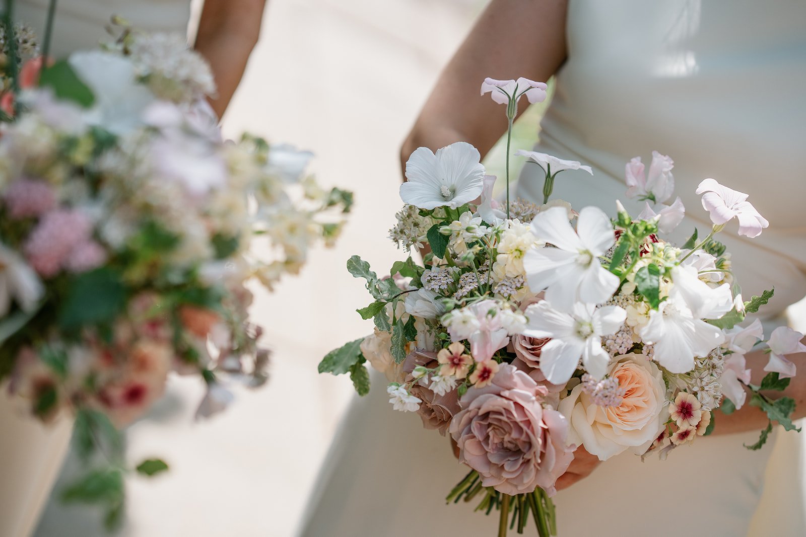Cream, pink and coral floral arrangements at wedding styled by a UK luxury wedding planner