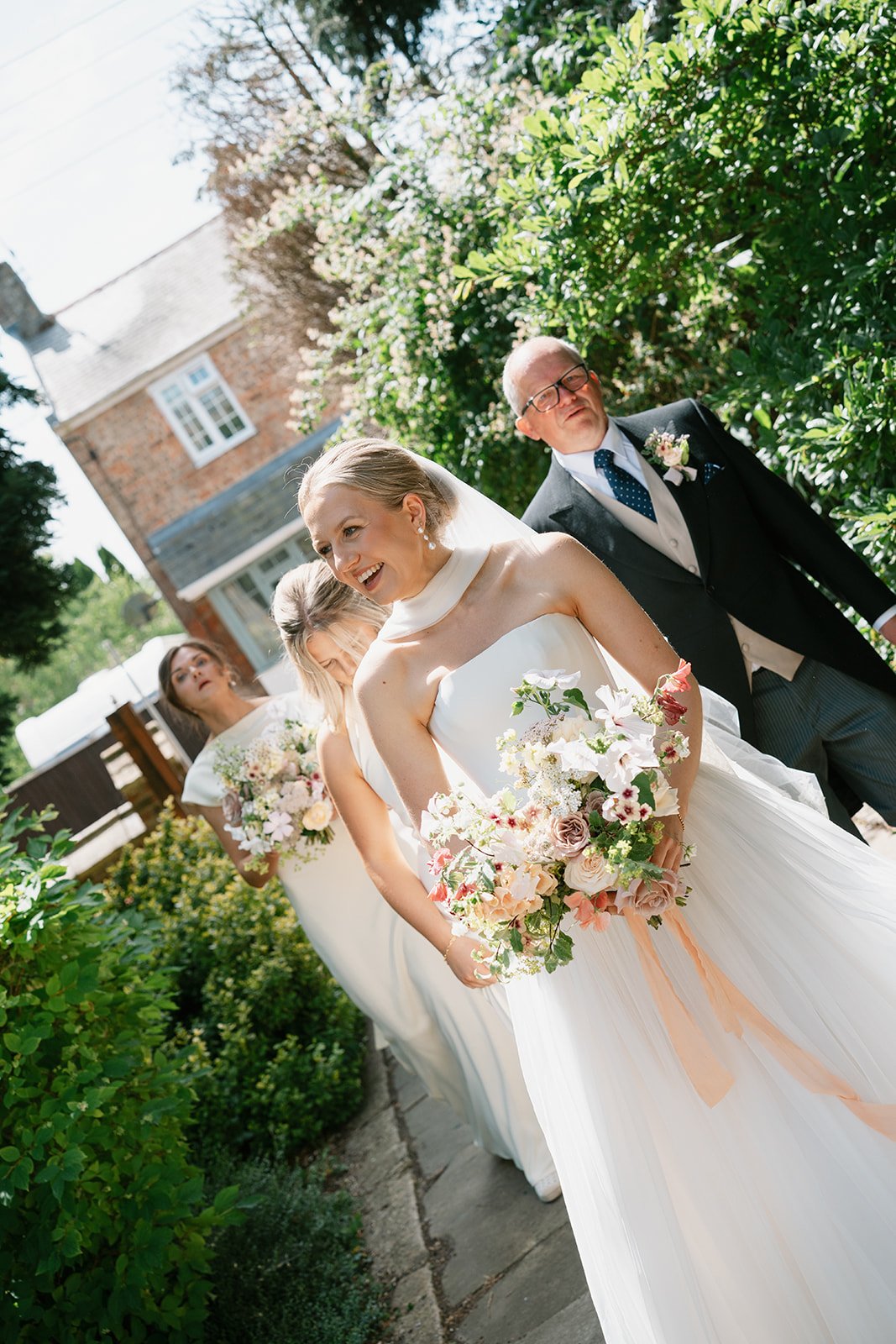Bride with her bridesmaids and father of the bride before church ceremony, coordinated by Hardesty Event Design