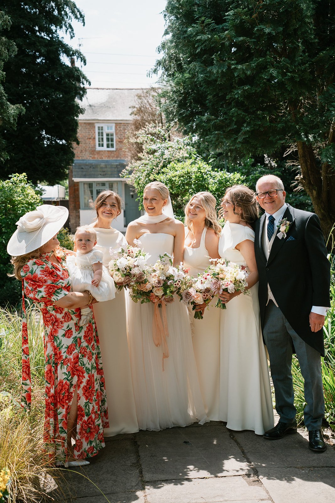 Bride with her bridesmaids, father of bride and mother of bride before church ceremony, coordinated by Hardesty Event Design