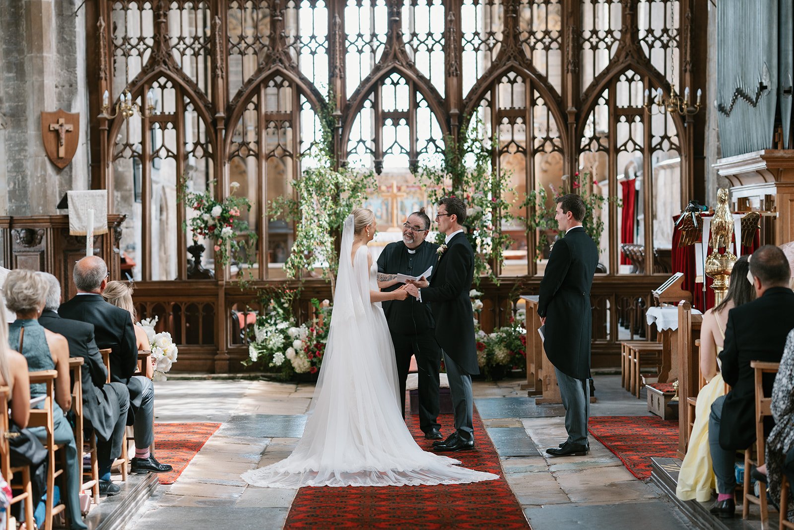 Bride and groom exchanging vows at a high-end country house wedding in Norfolk planned by a luxury UK wedding planner