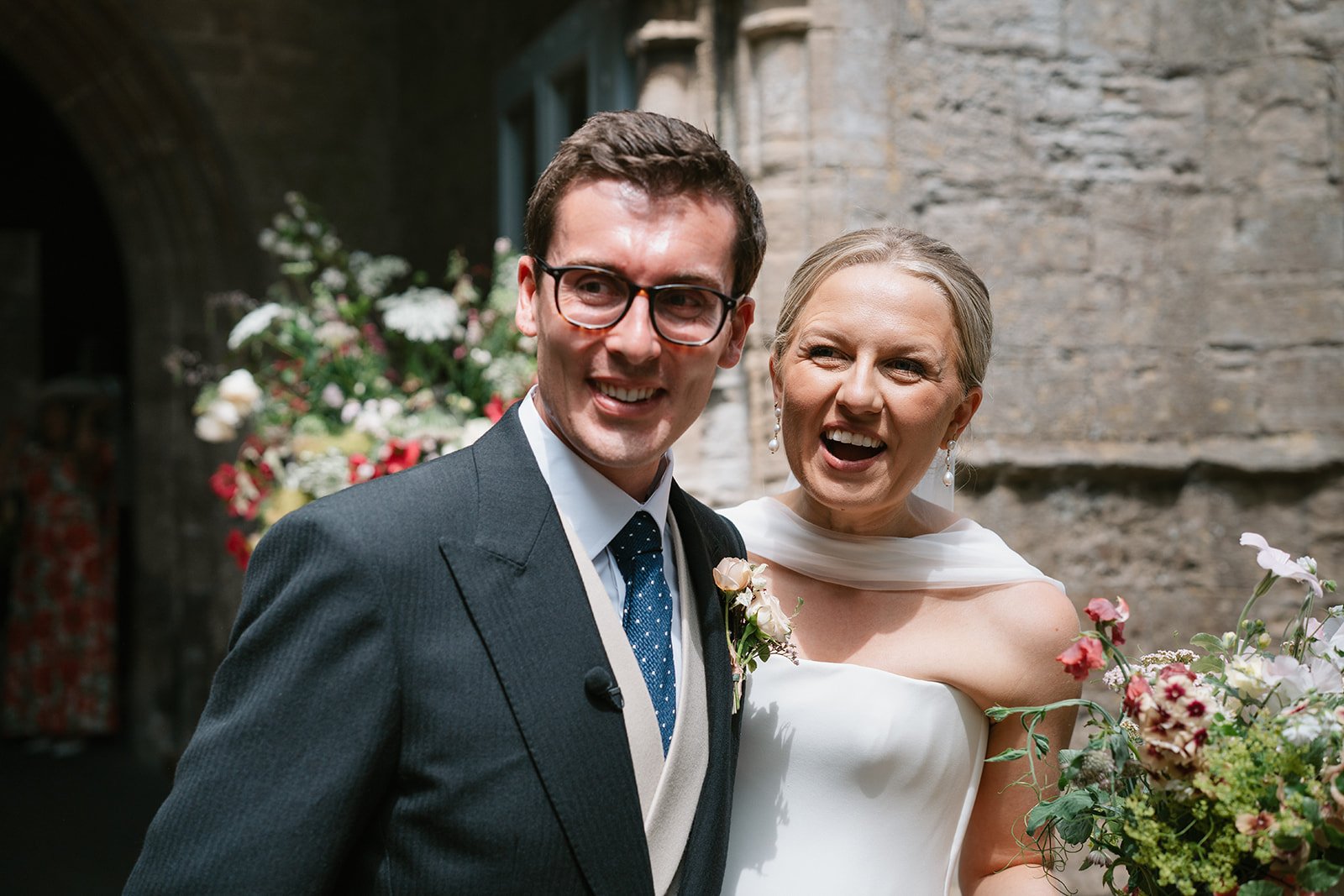 Bride and groom beaming post-ceremony at their high-end country house wedding in Norfolk planned by a luxury UK wedding planner