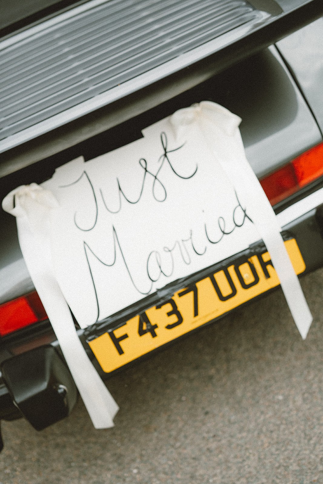 a just married sign attached to the getaway wedding car for charlotte and ed on their luxury wedding day