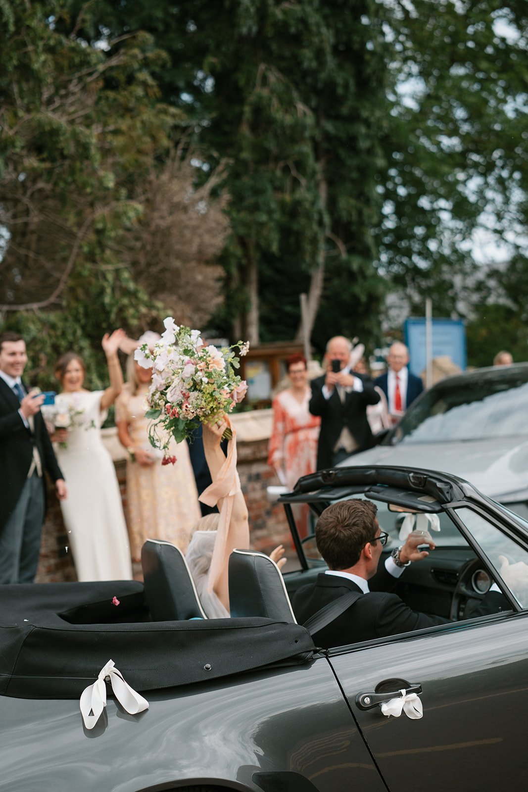 bride and groom departing from their wedding ceremony following a church service close by to their home, coordinated by UK wedding planners Hardesty Event Design