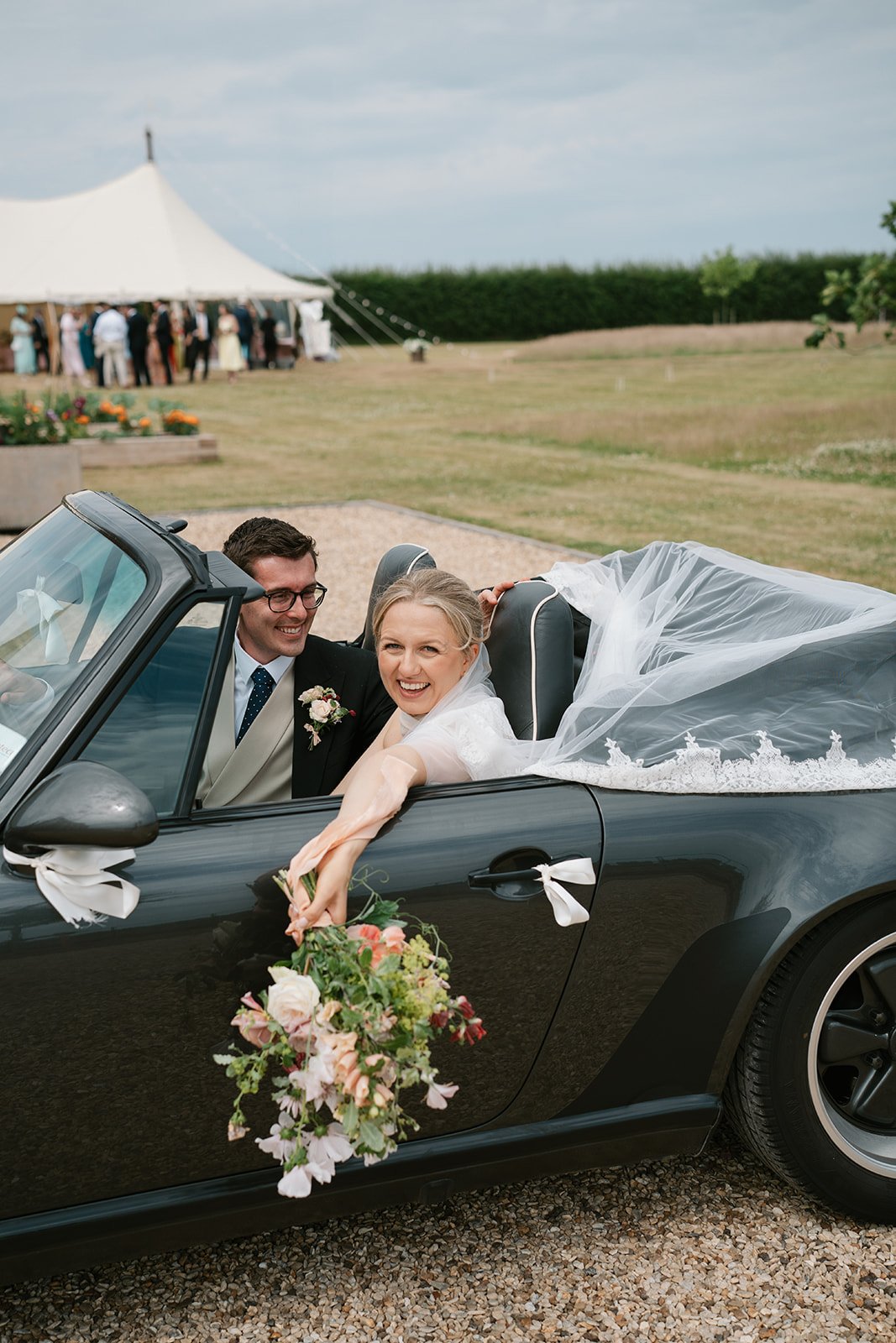 bride and groom arriving at their marquee wedding reception at home, coordinated by Hardesty Event Design