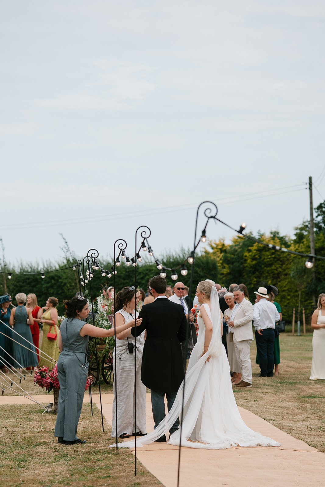 Bride and groom standing together in their garden marquee wedding, coordinated by Hardesty Event Design