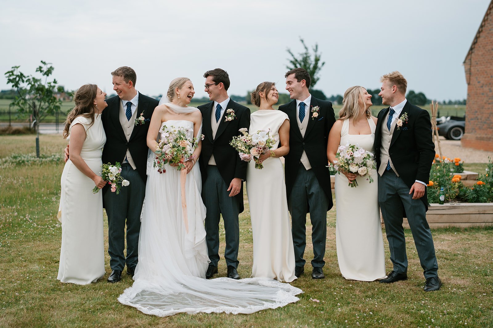 bride and groom with bridal party at their at-home marquee wedding in south lincolnshire