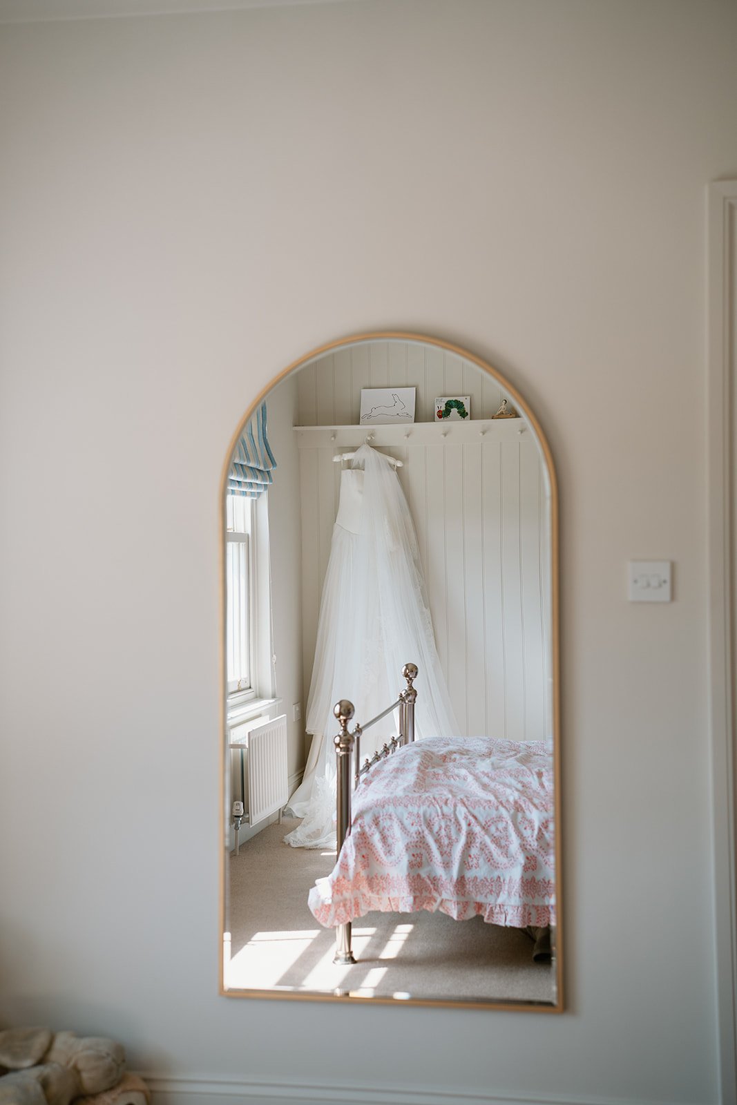 Emma Beaumont bridal gown hung in the bedroom of the bride for her at home marquee wedding planned by uk wedding planner Hardesty Event Design