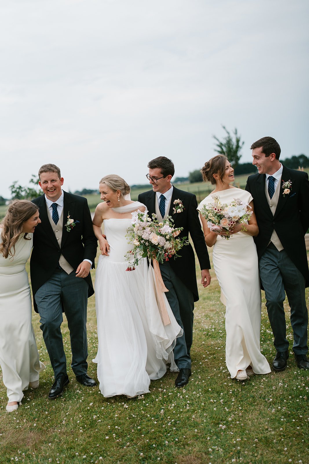 bride and groom with bridal party at their at-home marquee wedding in south lincolnshire