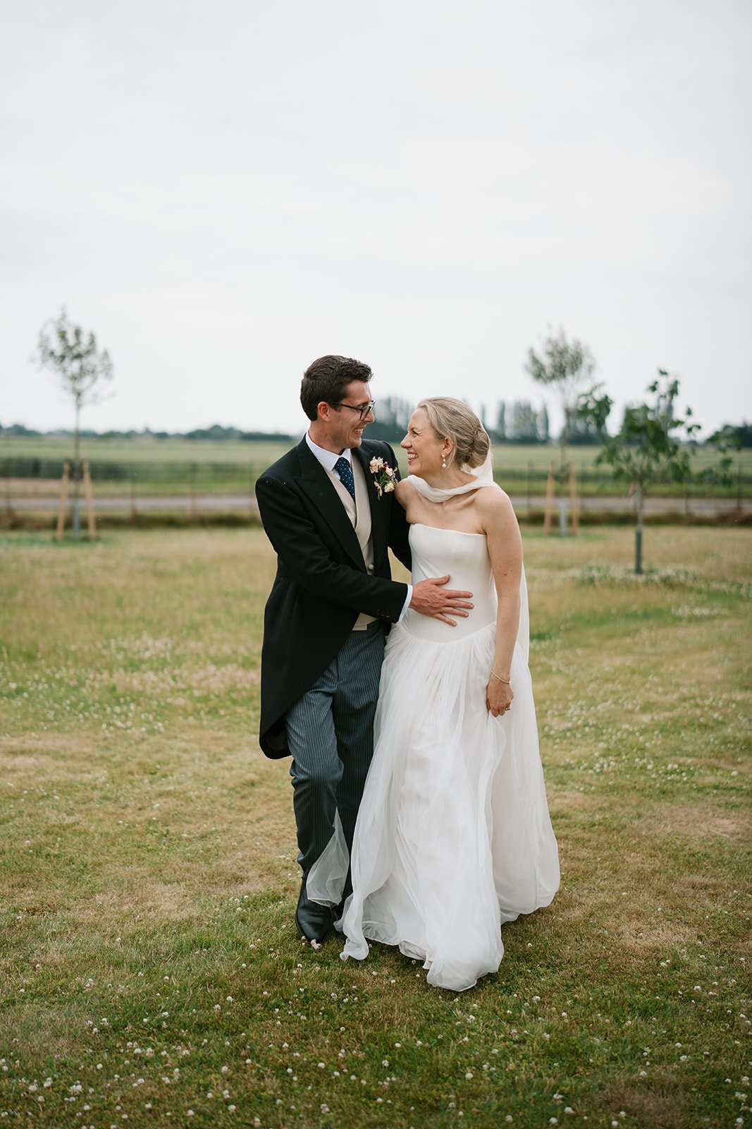 Bride and groom standing together in their garden marquee wedding, coordinated by Hardesty Event Design