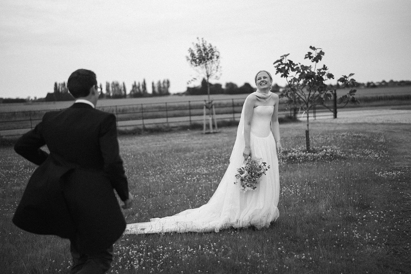 Bride and groom standing together in their garden marquee wedding, coordinated by Hardesty Event Design