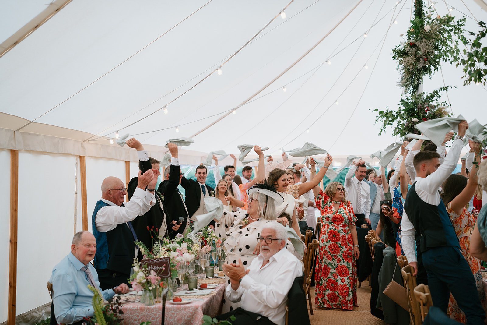 Wedding guests welcoming in the new Mr and Mrs at a garden marquee wedding in South Linconshire, coordinated by luxury UK wedding planners Hardesty Event Design