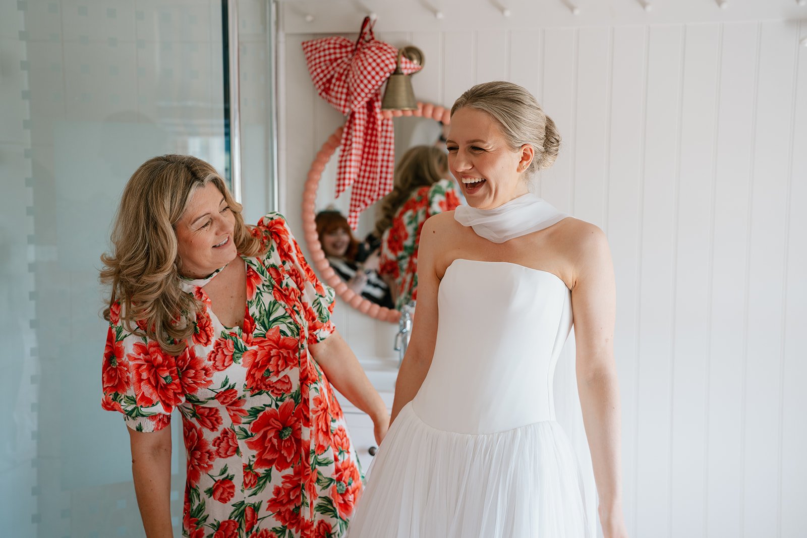Charlotte, the bride in her wedding dress with her mum before she gets married at her wedding planned by luxury wedding planner Hardesty Event Design