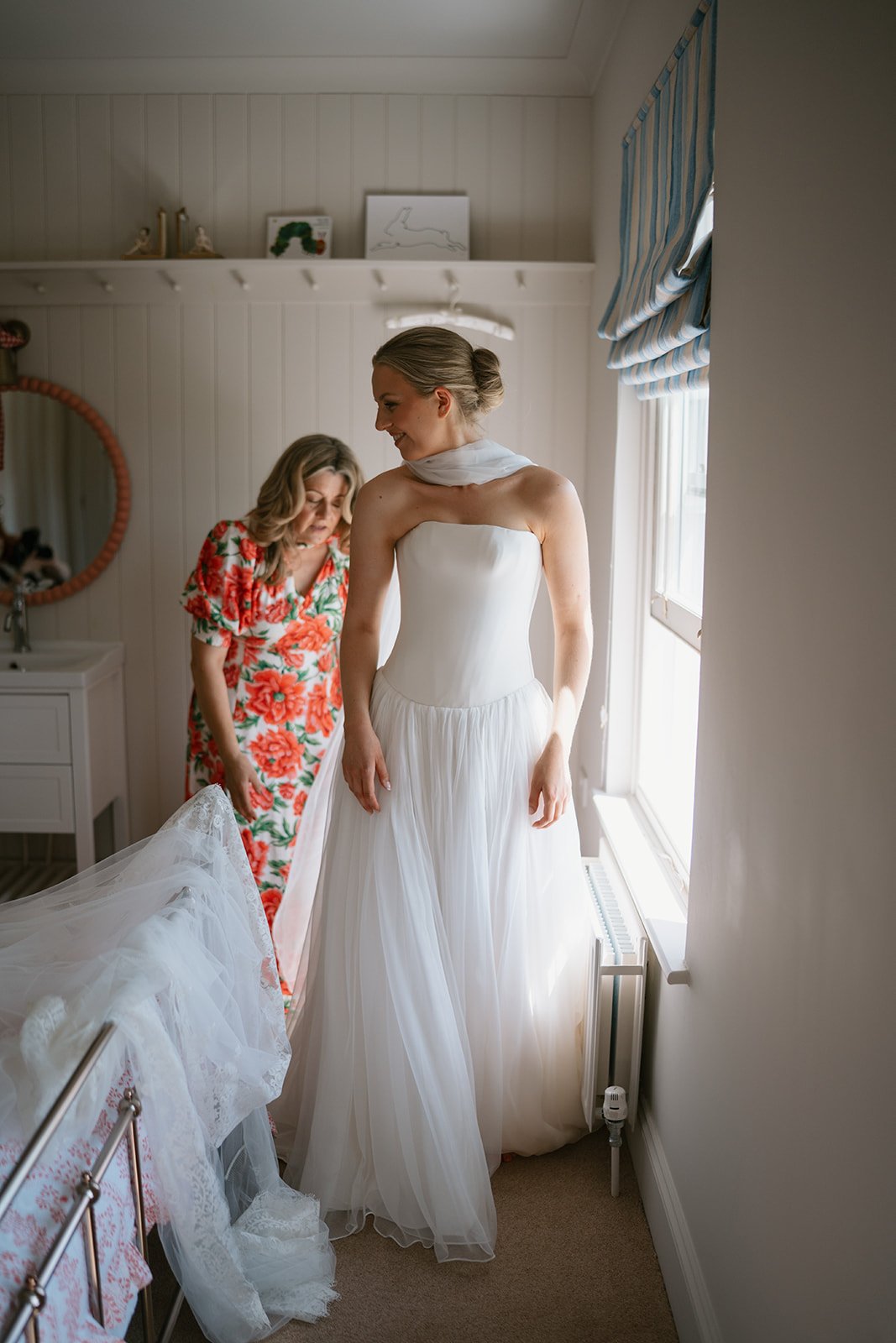Charlotte, the bride in her wedding dress with her mum before she gets married at her wedding planned by luxury wedding planner Hardesty Event Design
