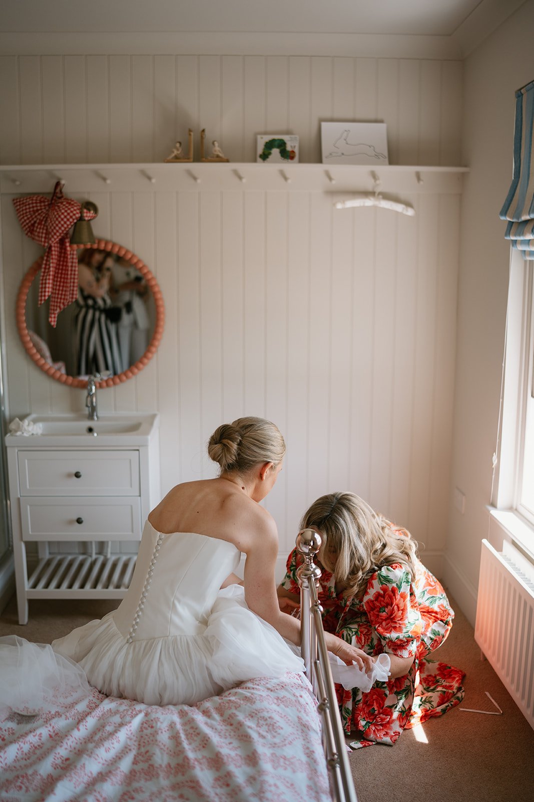Charlotte, the bride in her wedding dress with her mum before she gets married at her wedding planned by luxury wedding planner Hardesty Event Design
