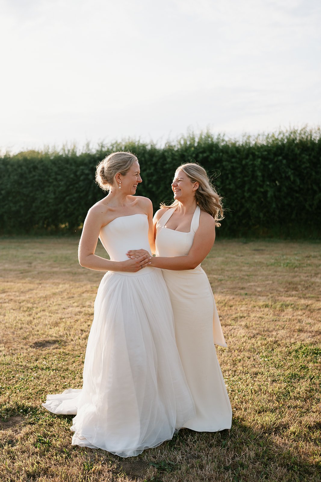 bride and bridesmaid on wedding day at at-home marquee wedding in Norfolk